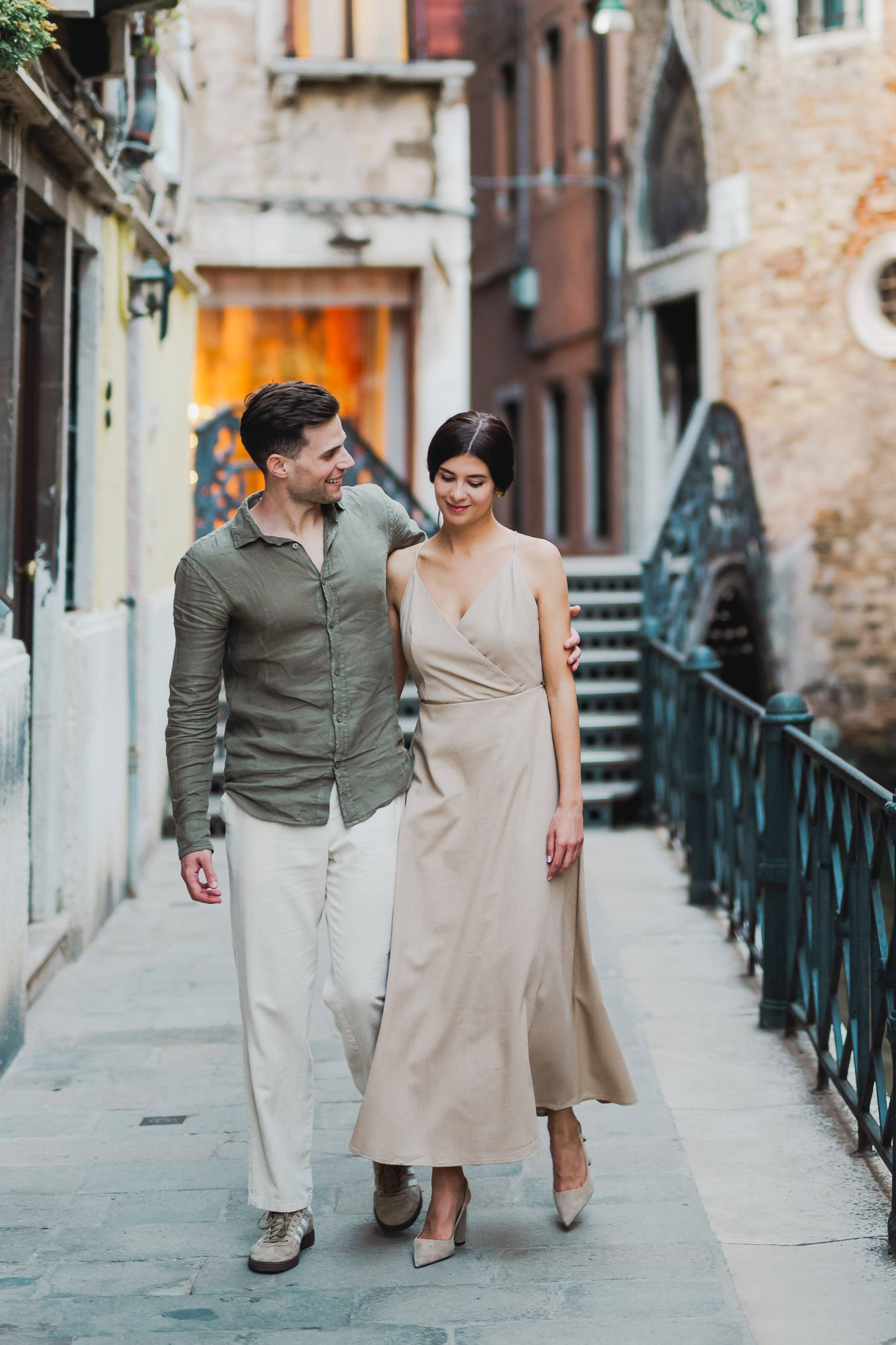 Couple sharing a private moment beside a Venetian canal