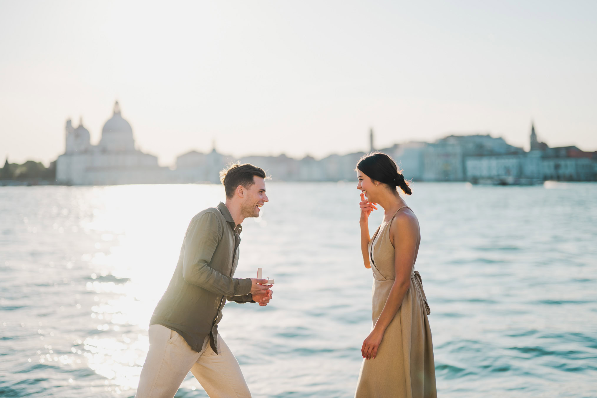 Man proposing to his girlfriend at sunset on San Giorgio Maggiore island