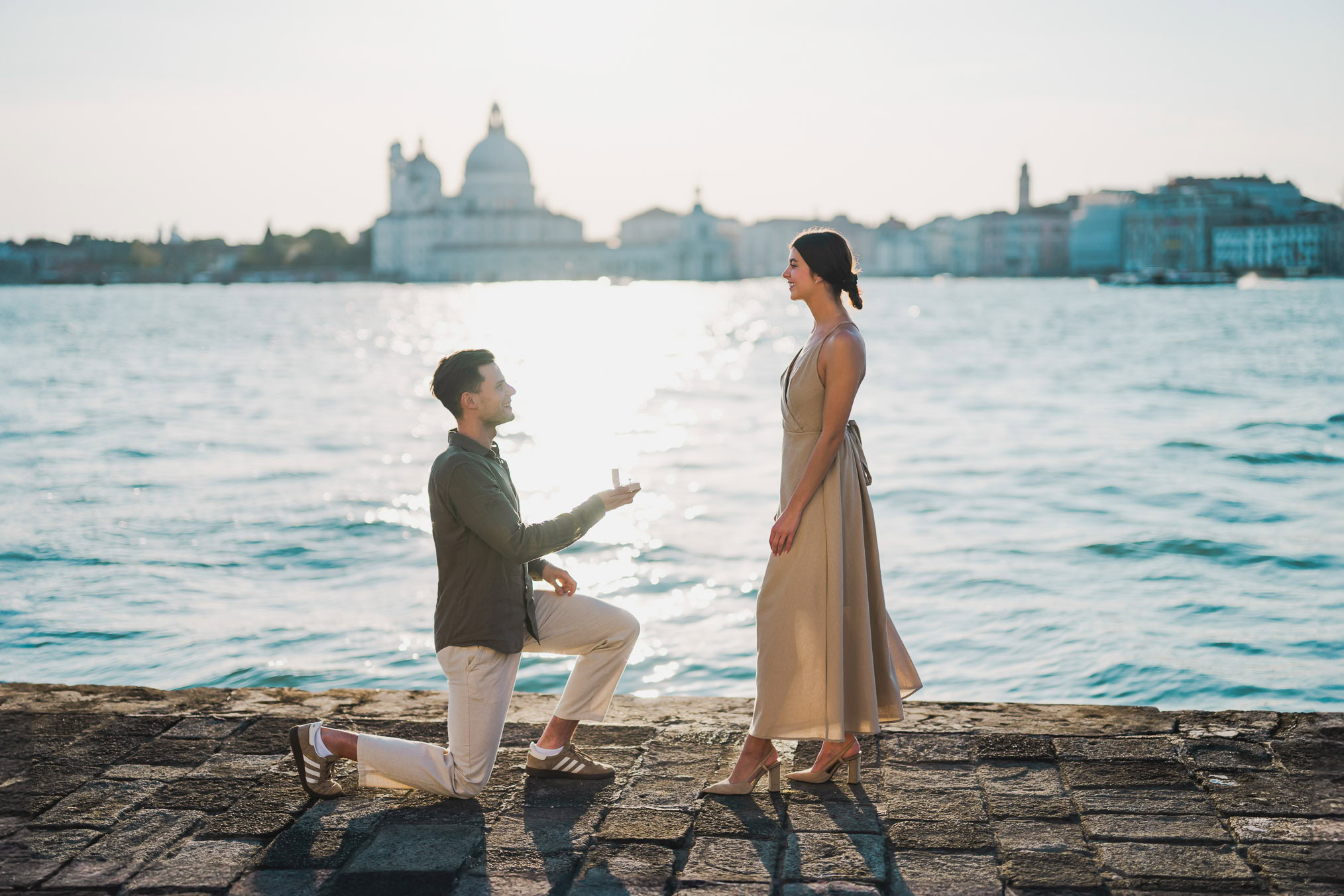 Man proposing to his girlfriend at sunset on San Giorgio Maggiore island