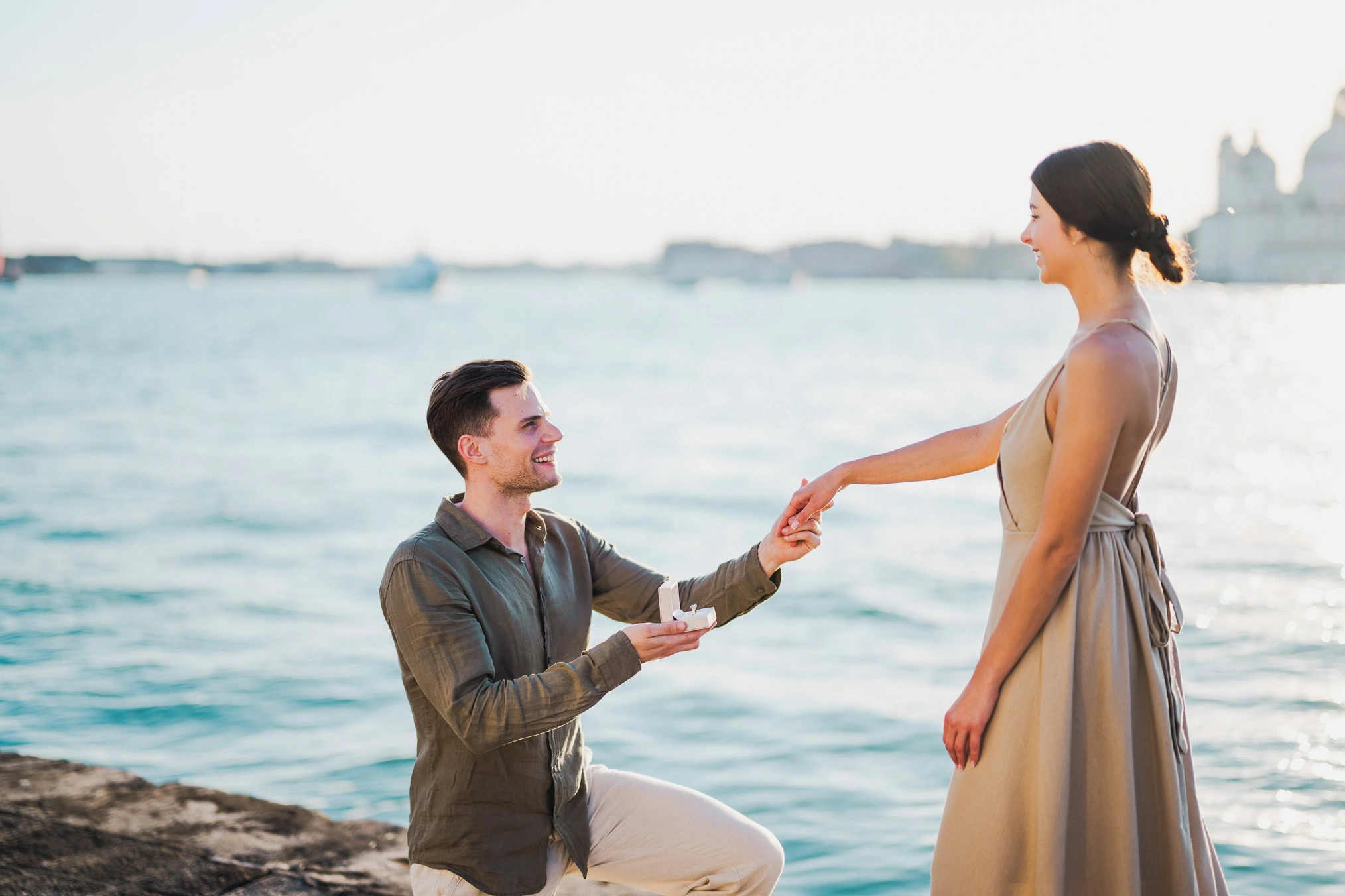 Man proposing to his girlfriend at sunset on San Giorgio Maggiore island