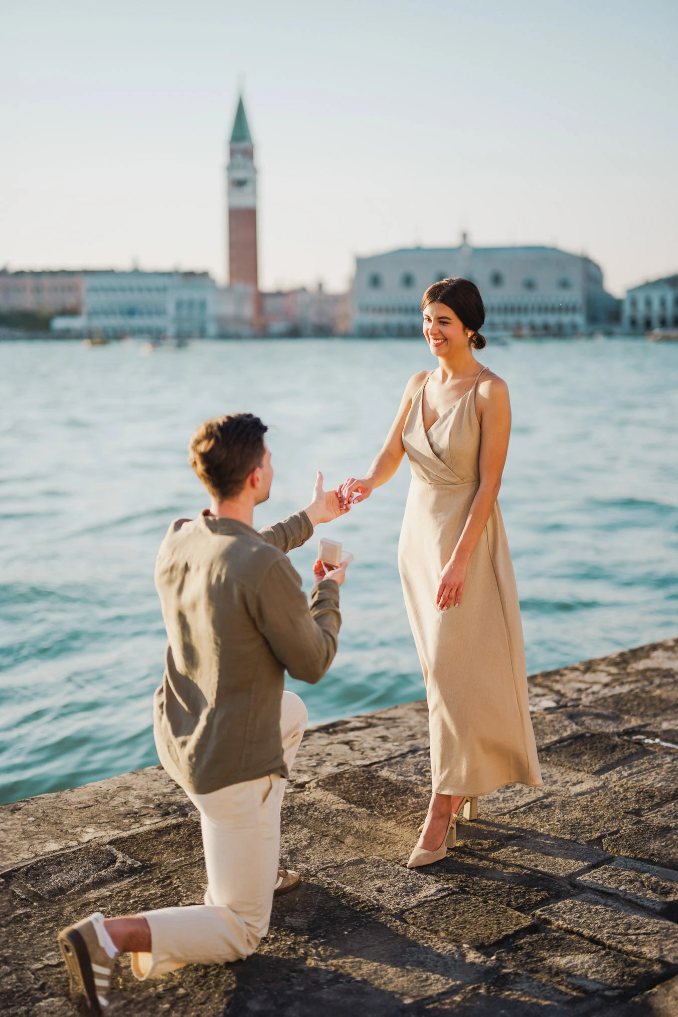 Man proposing to his girlfriend at sunset on San Giorgio Maggiore island