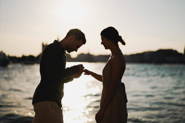 Man proposing to his girlfriend at sunset on San Giorgio Maggiore island