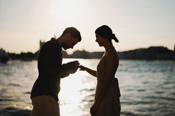 Man proposing to his girlfriend at sunset on San Giorgio Maggiore island