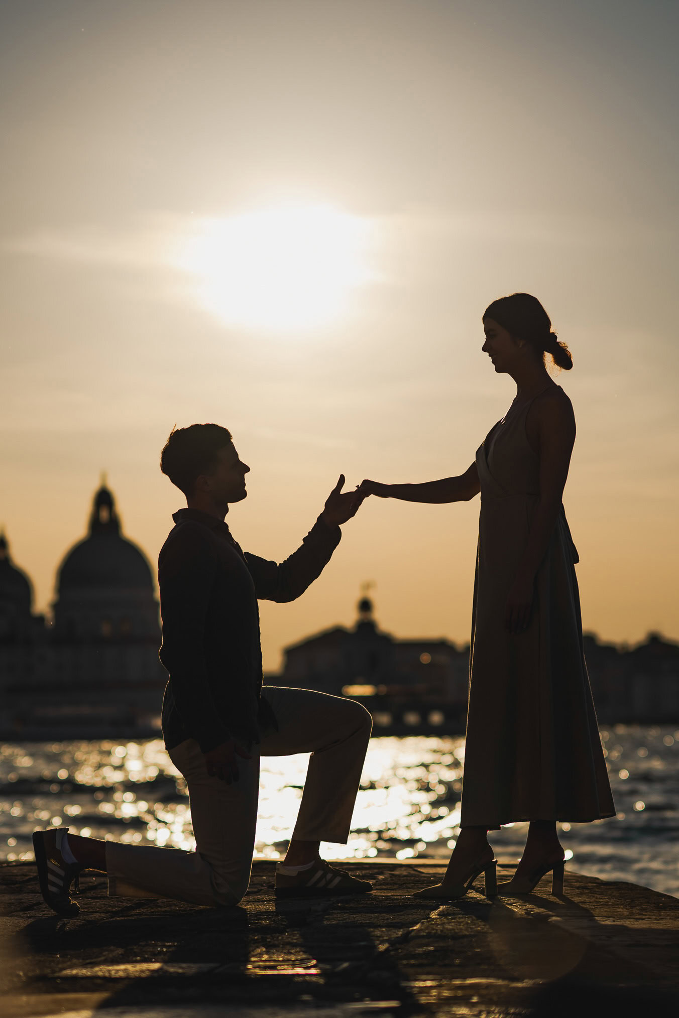 Man proposing to his girlfriend at sunset on San Giorgio Maggiore island