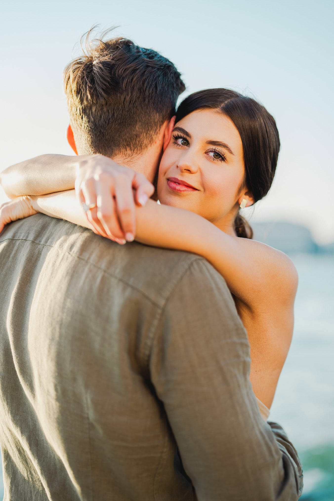 Couple embracing joyfully after engagement in Venice