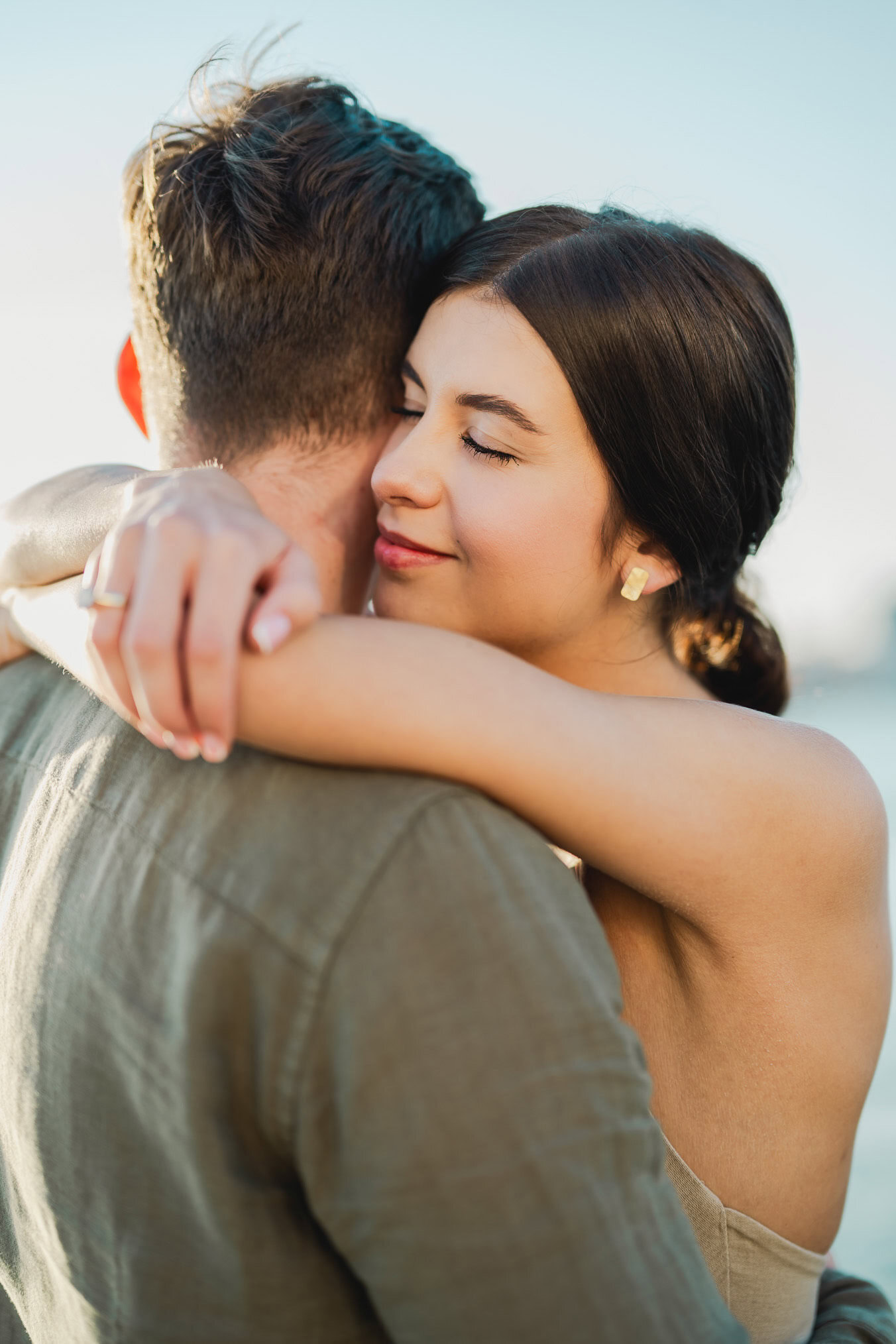 Couple embracing joyfully after engagement in Venice