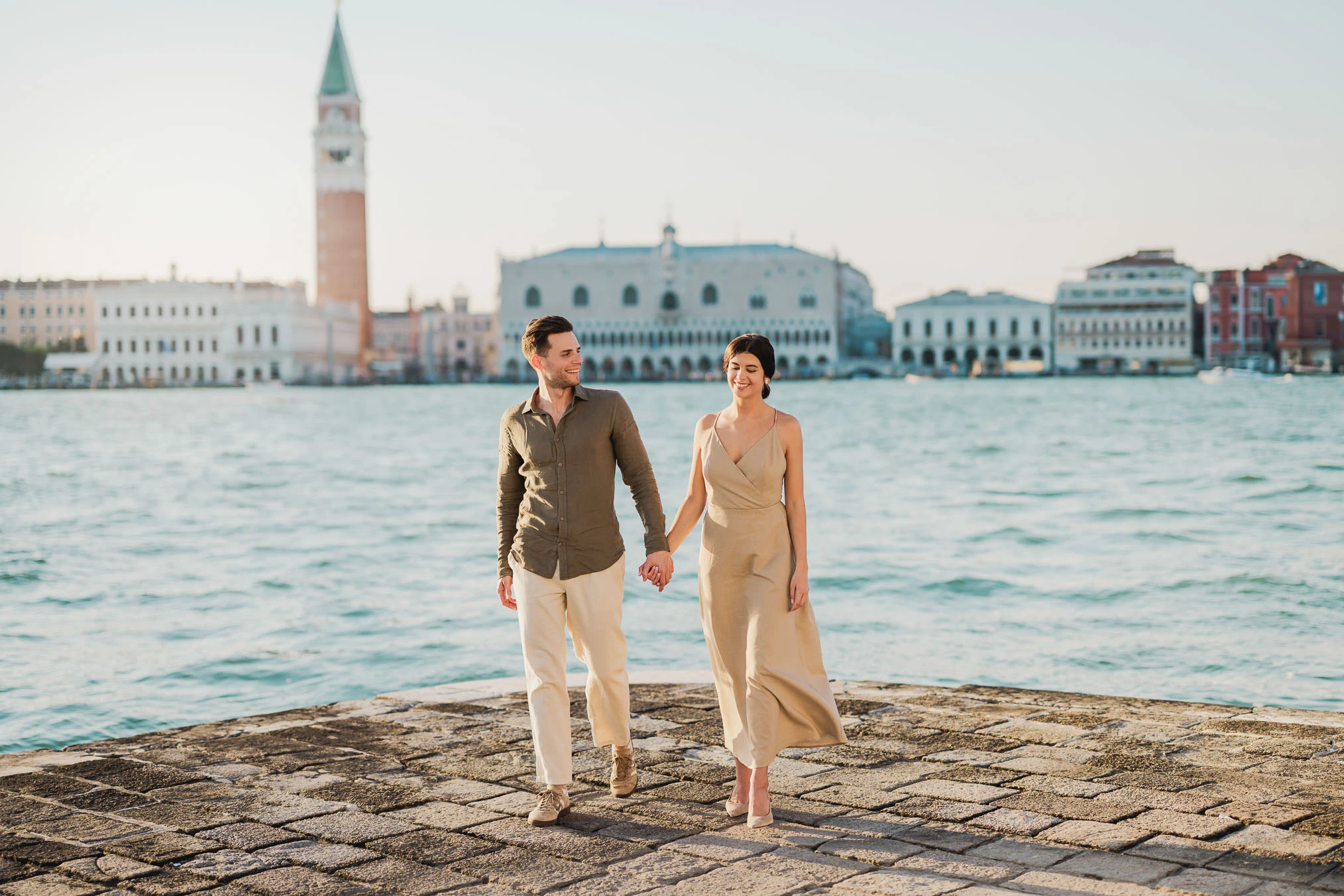 Couple embracing joyfully after engagement in Venice