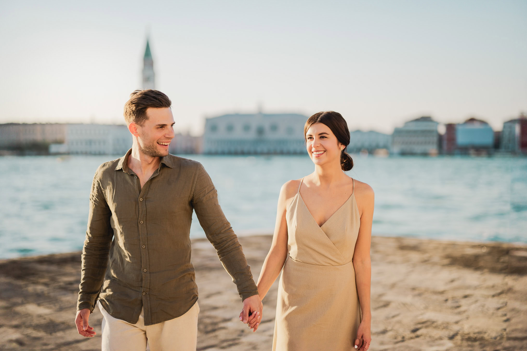 Couple embracing joyfully after engagement in Venice