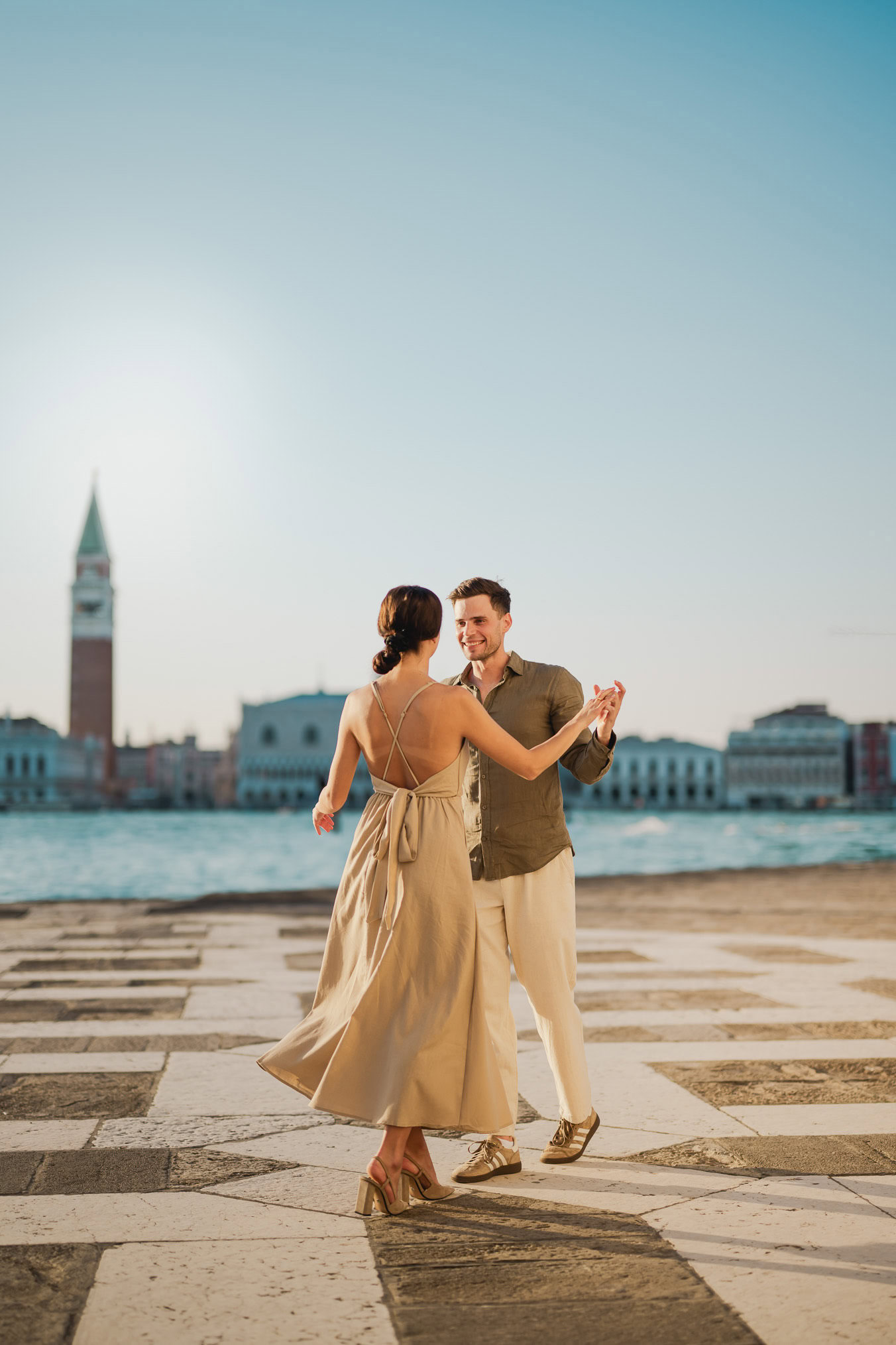 Couple embracing joyfully after engagement in Venice