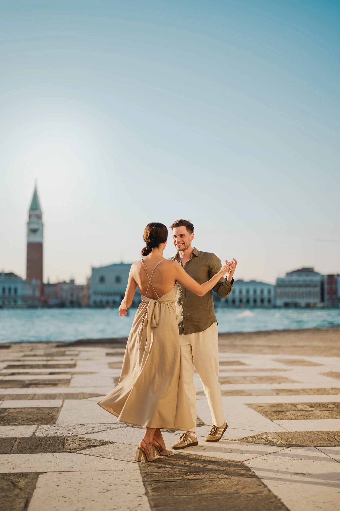 Couple embracing joyfully after engagement in Venice