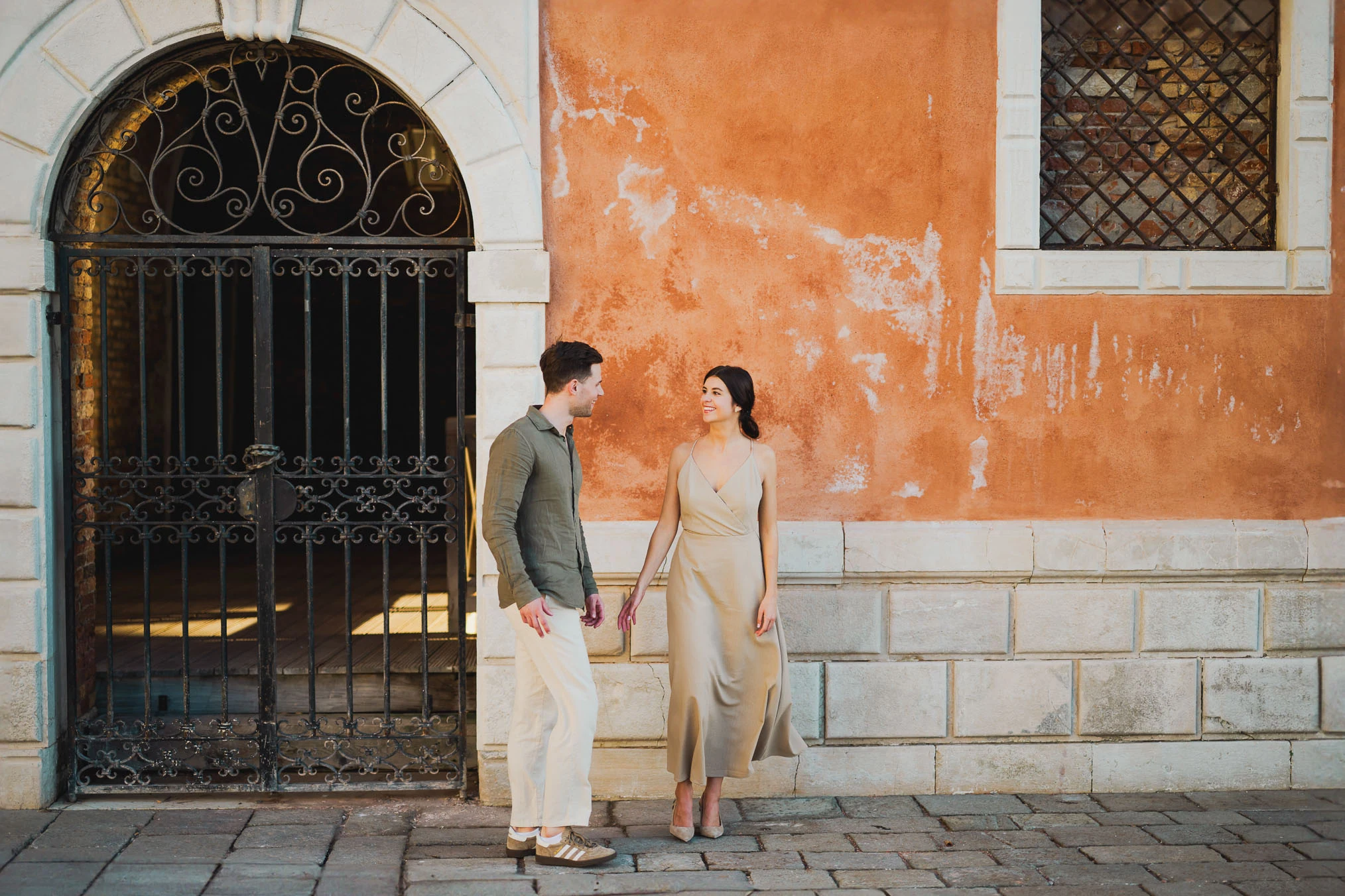 Couple embracing joyfully after engagement in Venice