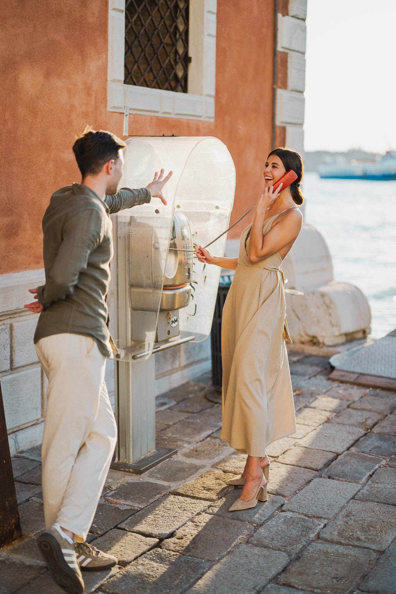 Couple embracing joyfully after engagement in Venice