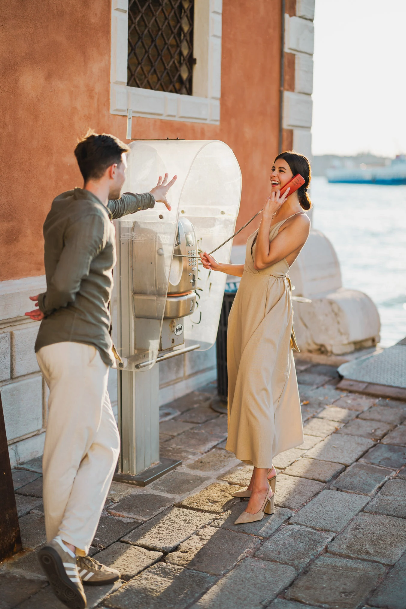 Couple embracing joyfully after engagement in Venice