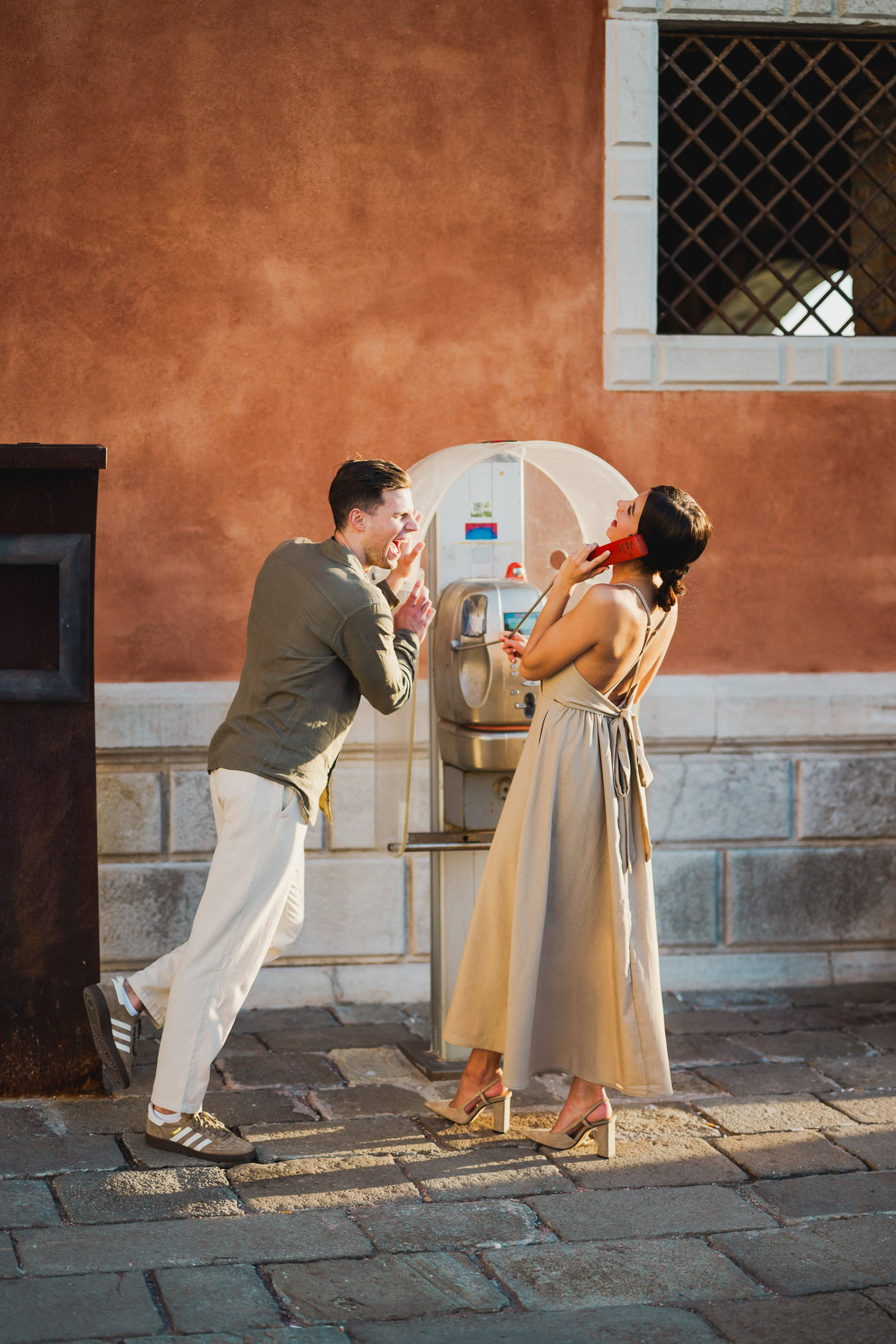 Couple embracing joyfully after engagement in Venice