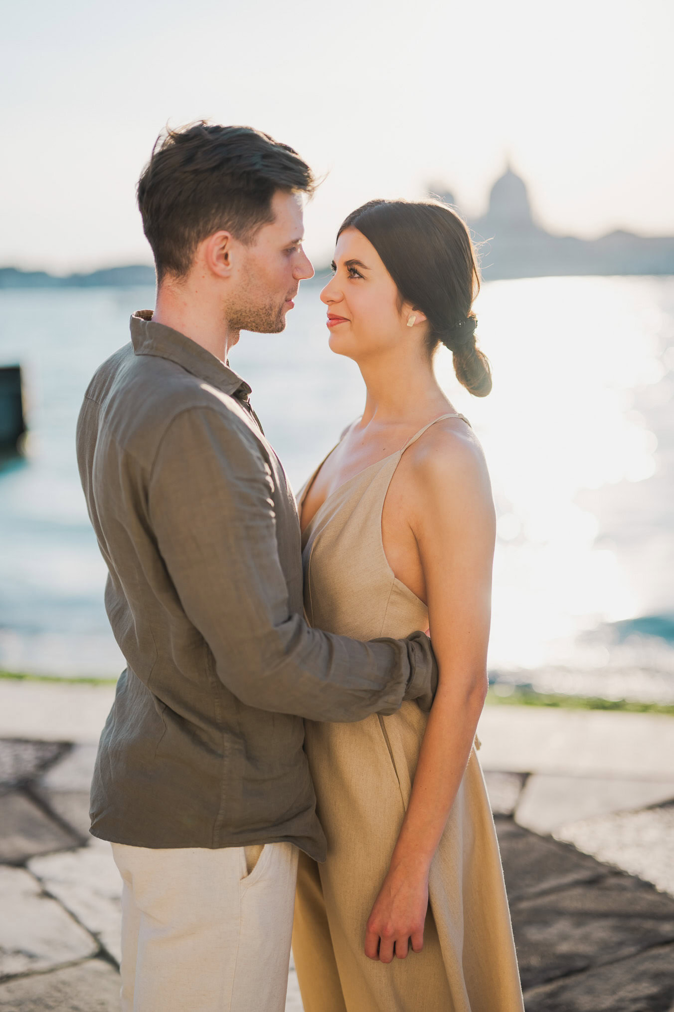 Couple embracing joyfully after engagement in Venice
