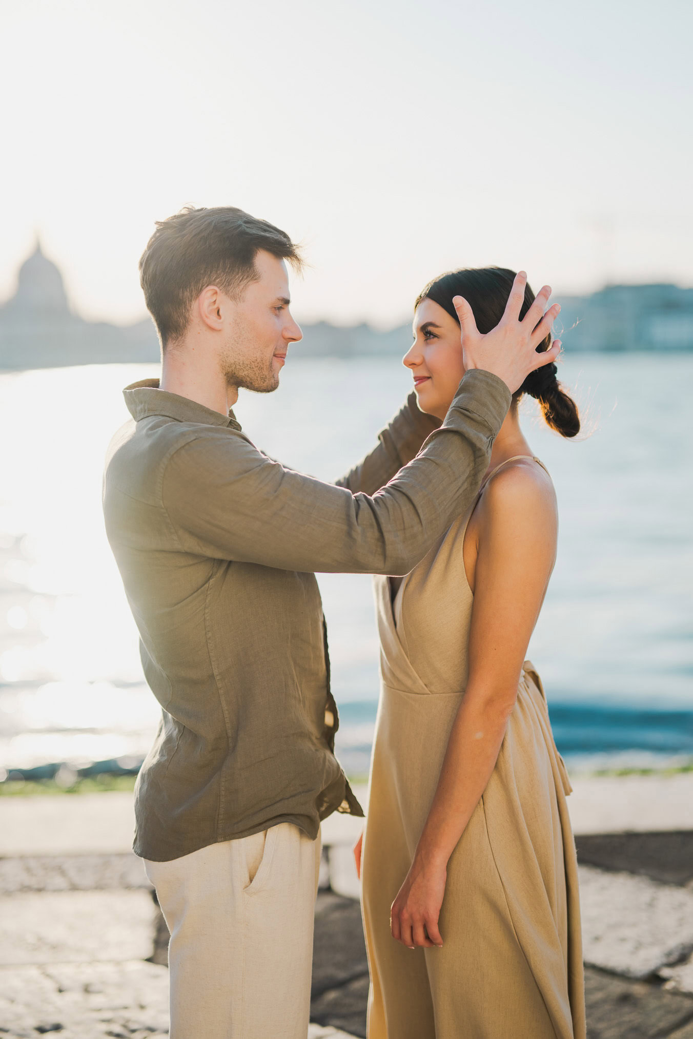 Couple embracing joyfully after engagement in Venice