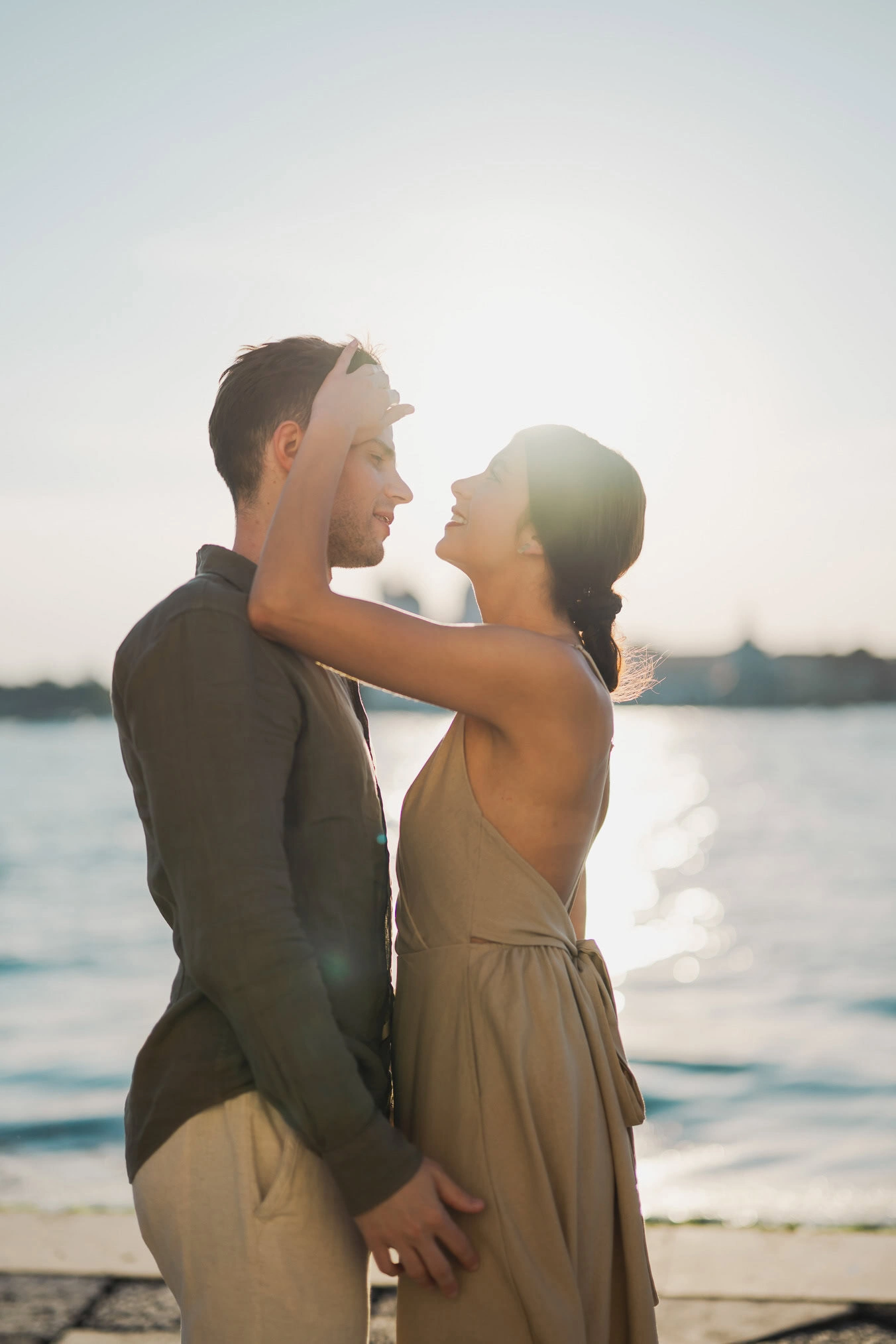 Couple embracing joyfully after engagement in Venice