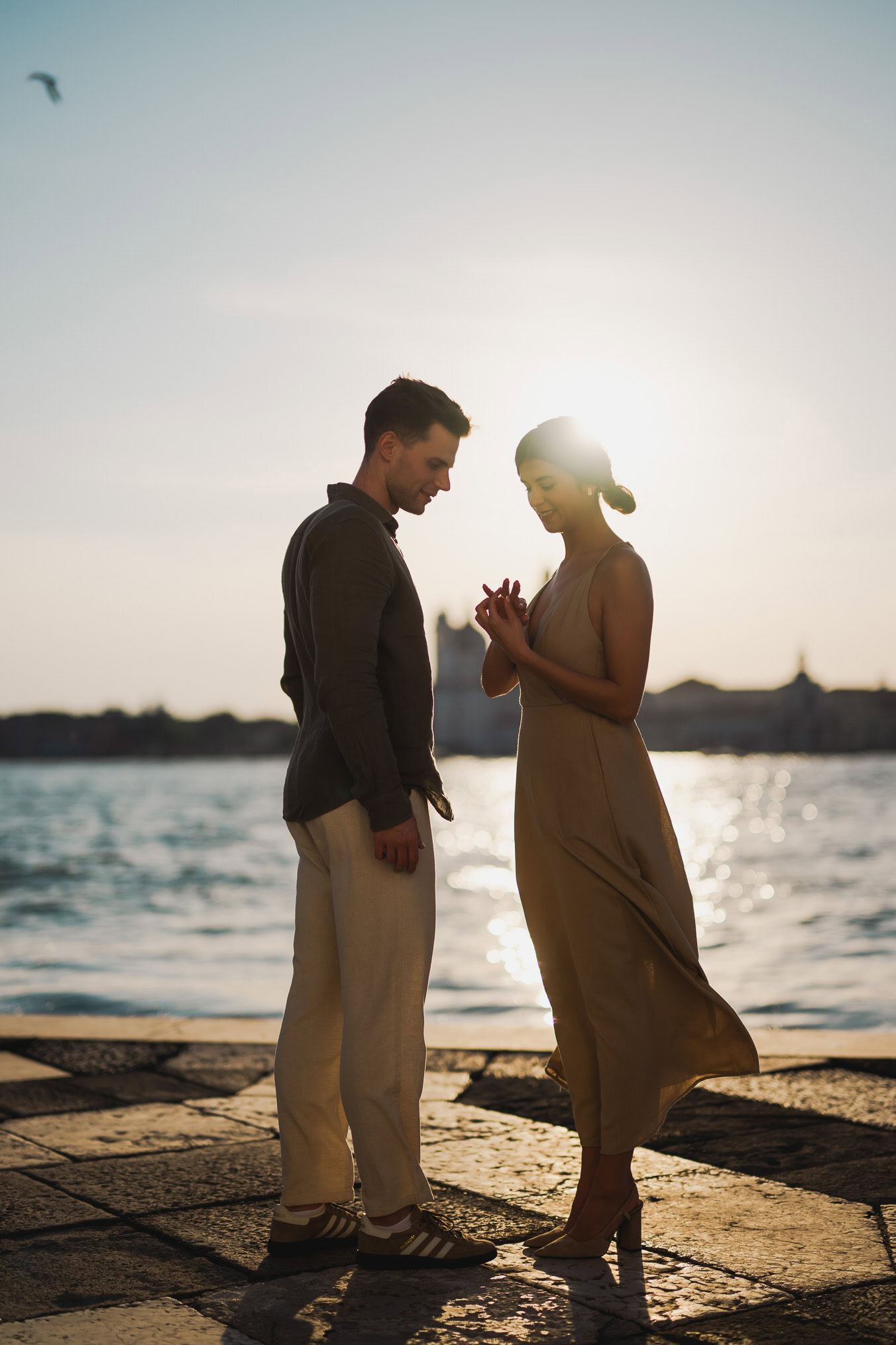 Couple embracing joyfully after engagement in Venice