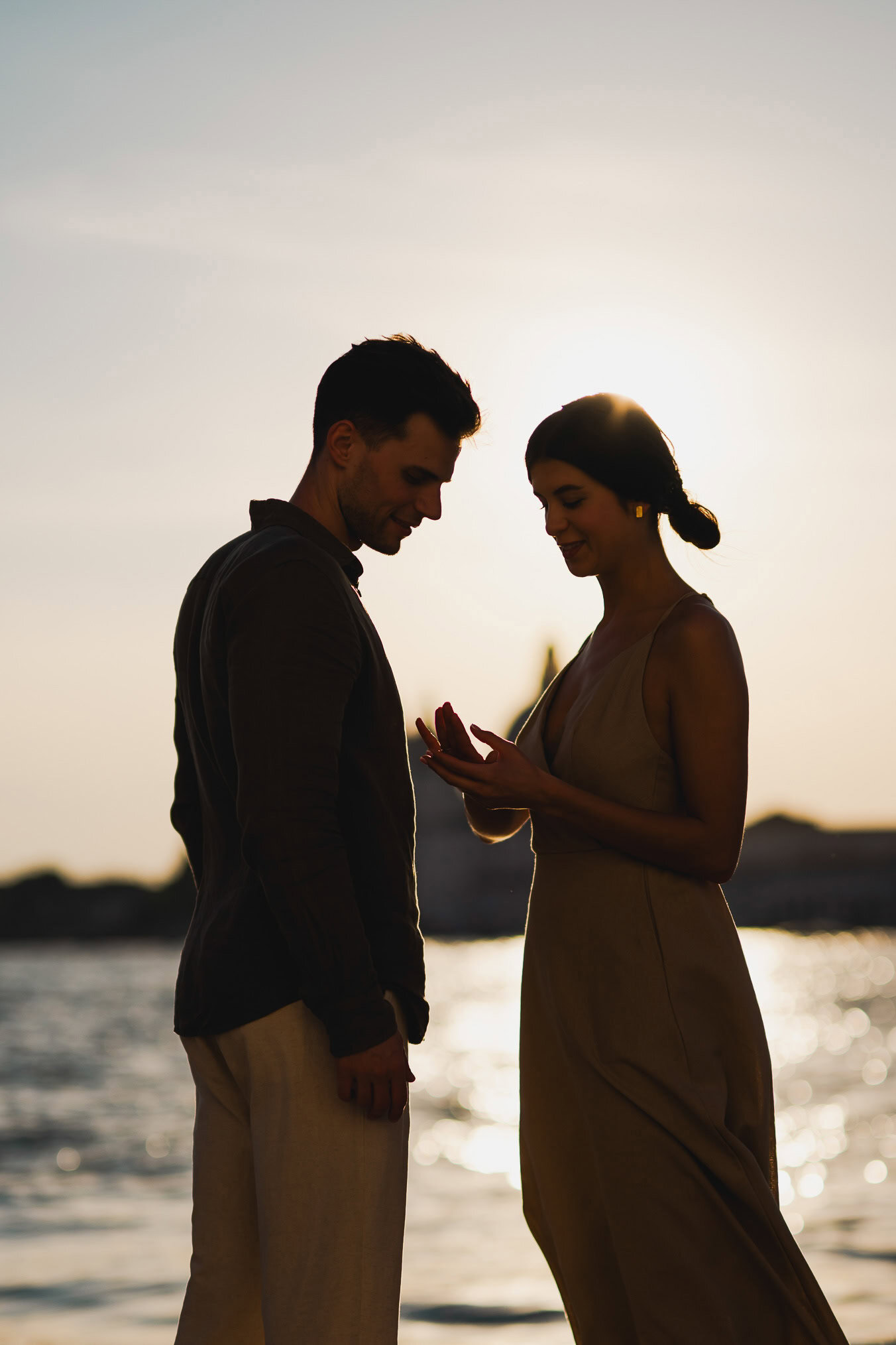 Couple embracing joyfully after engagement in Venice