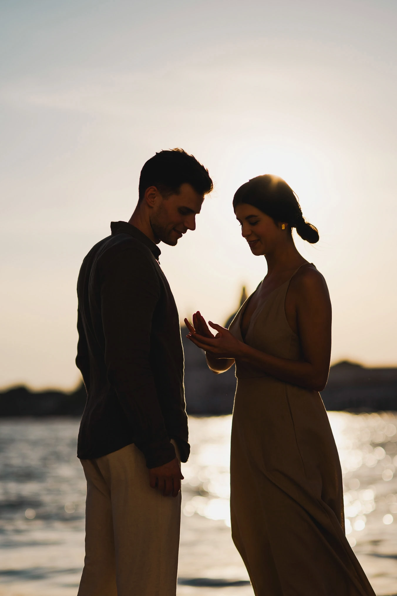 Couple embracing joyfully after engagement in Venice