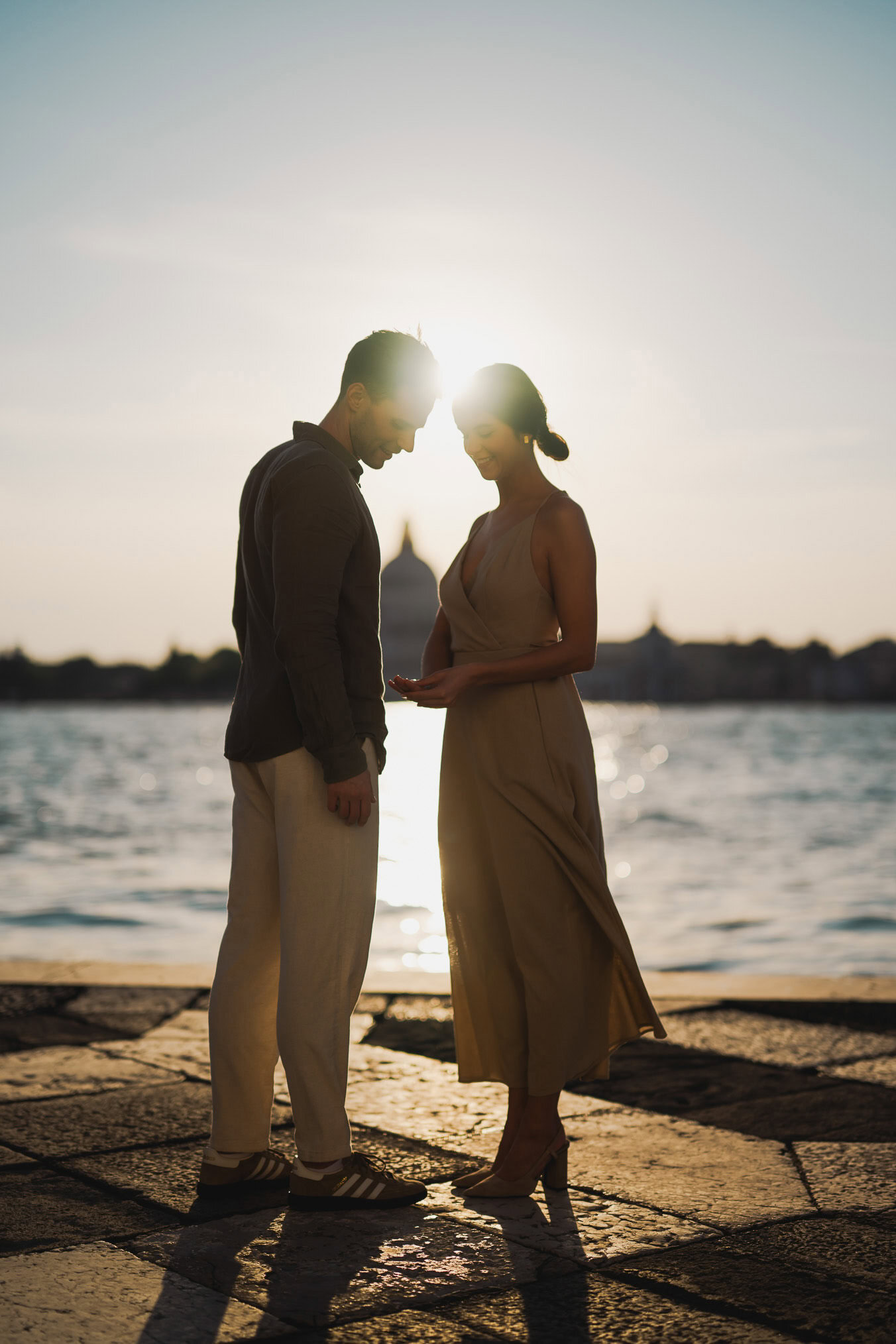Couple embracing joyfully after engagement in Venice