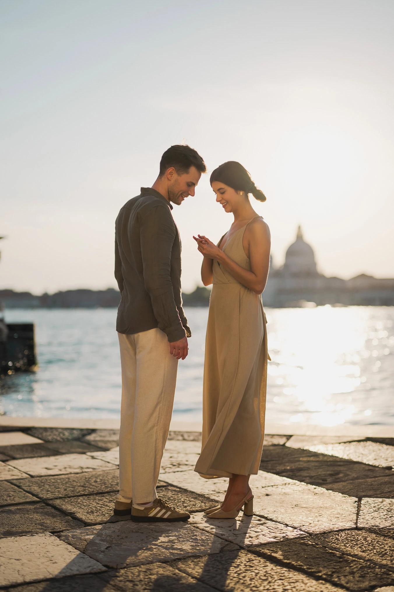 Couple embracing joyfully after engagement in Venice
