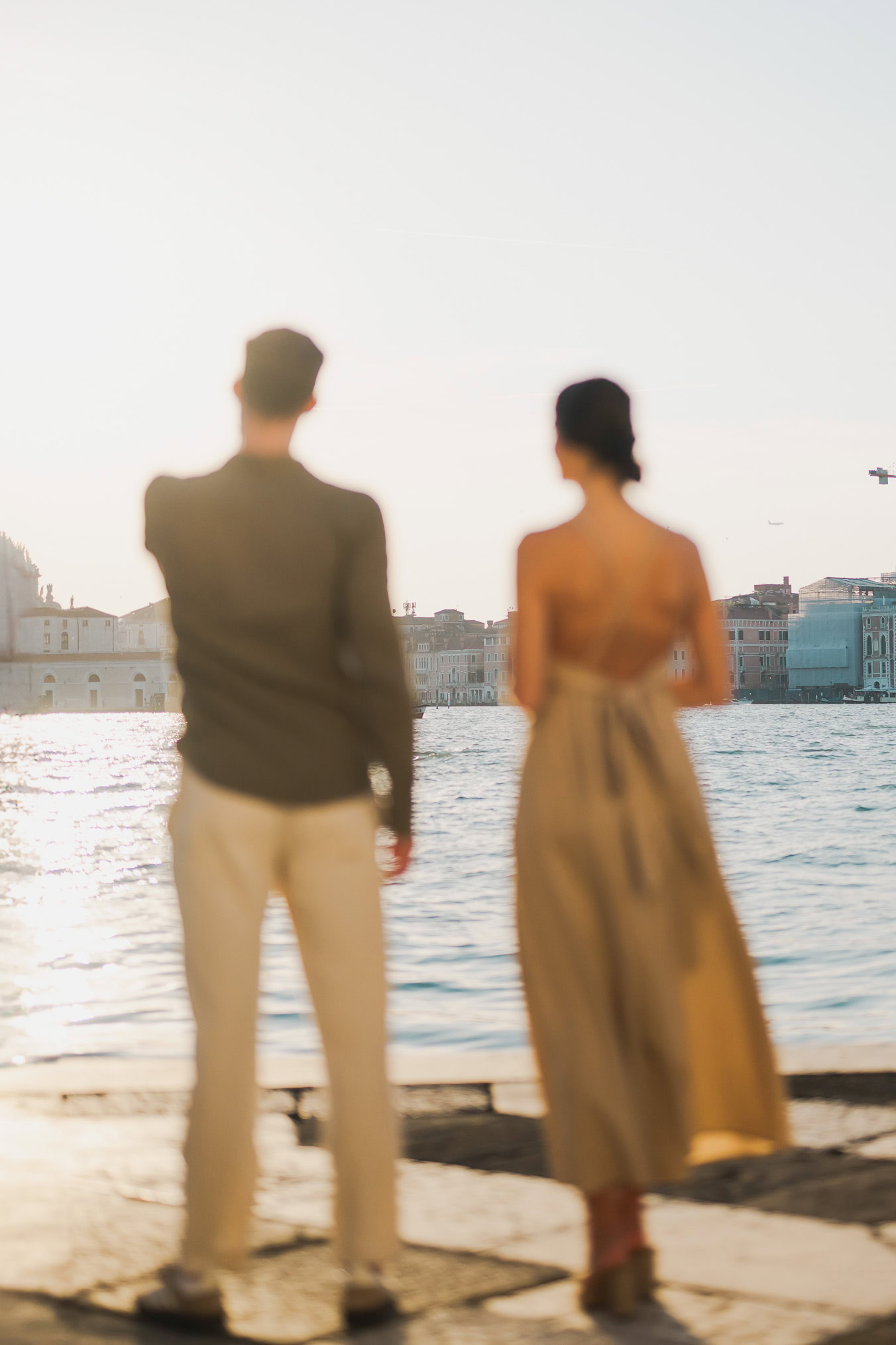 Couple embracing joyfully after engagement in Venice