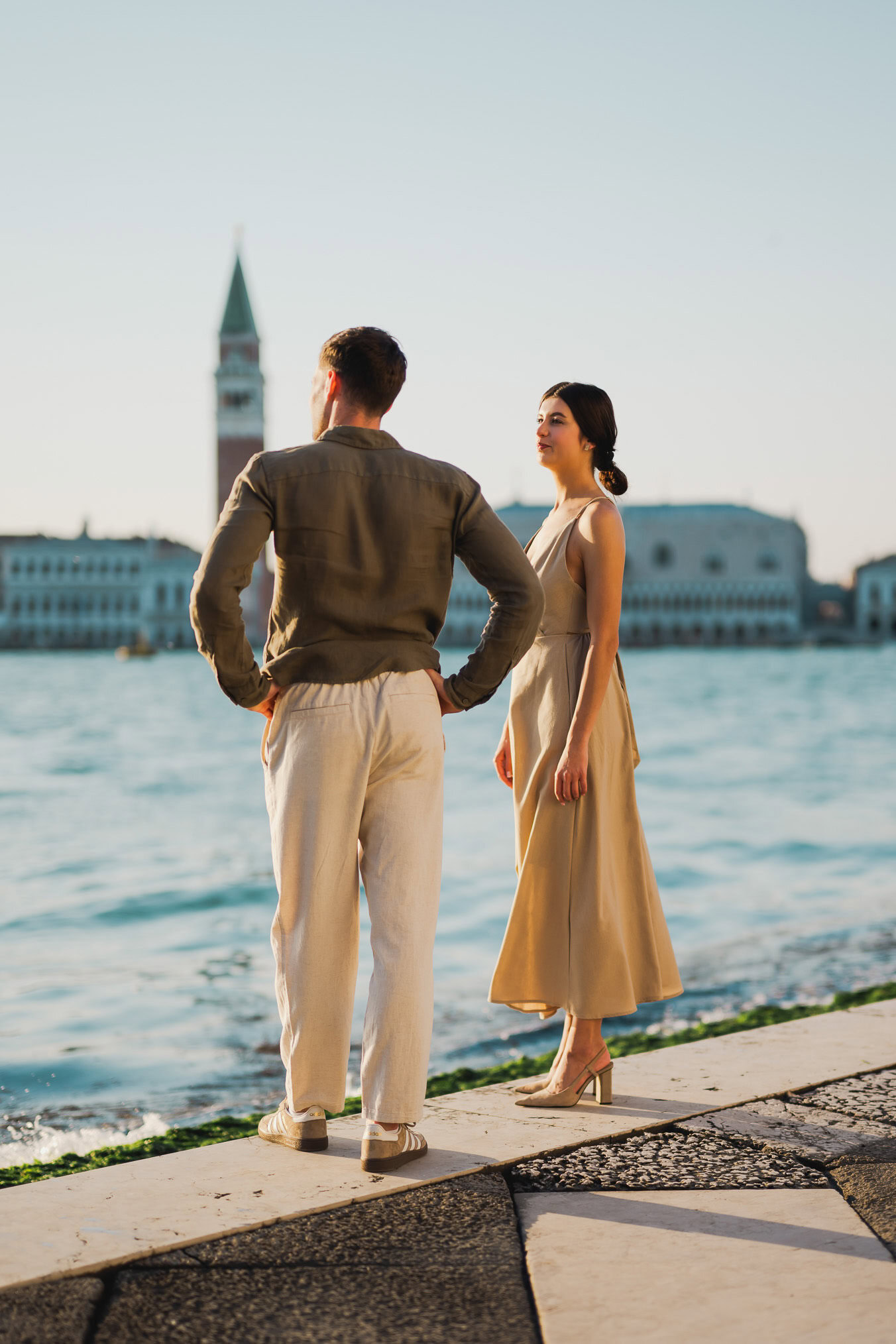 Couple embracing joyfully after engagement in Venice