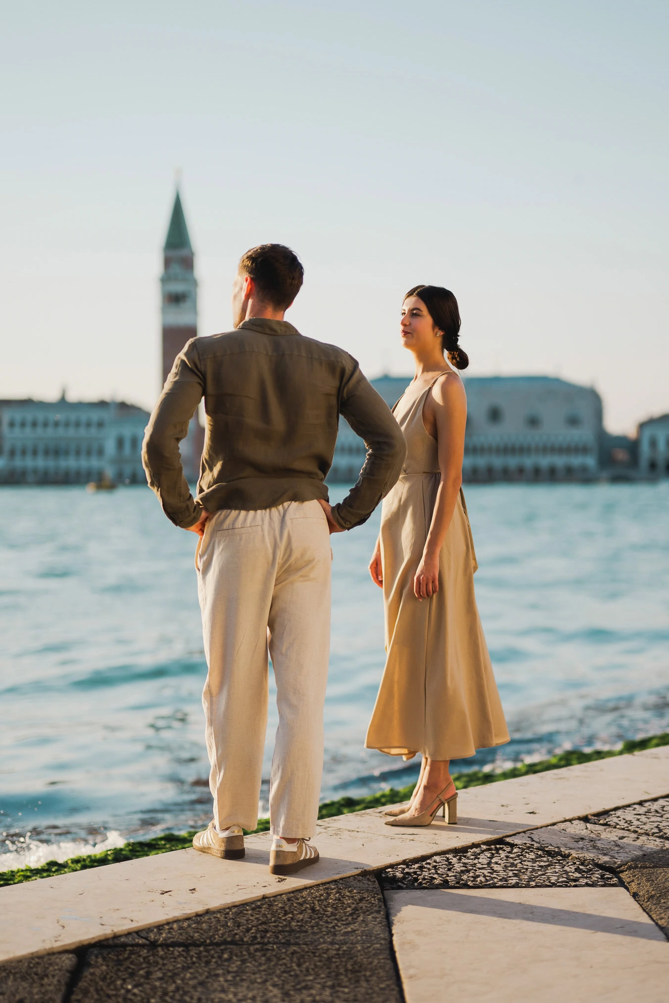 Couple embracing joyfully after engagement in Venice