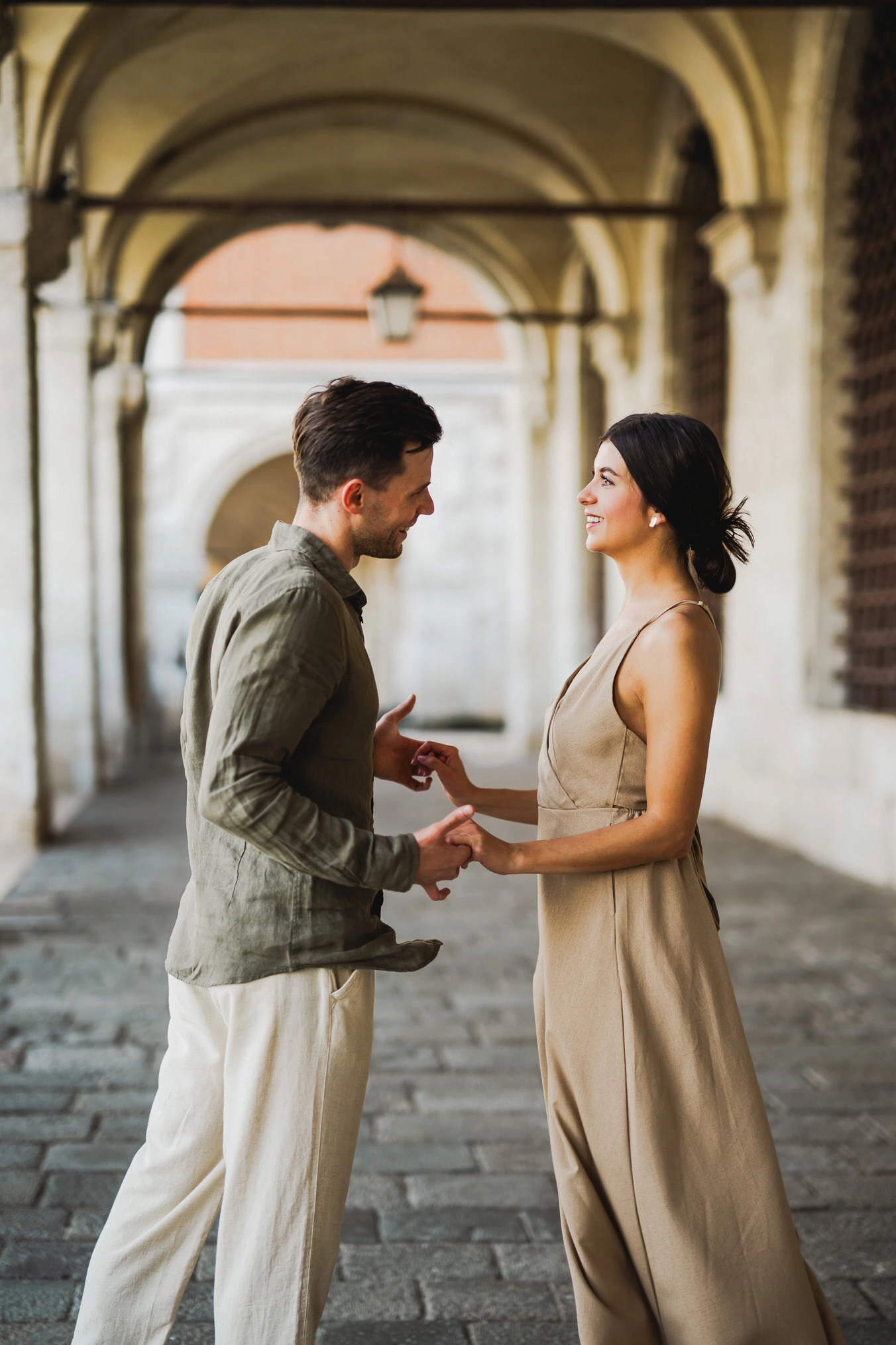 Engaged couple walking hand in hand through San Marco district
