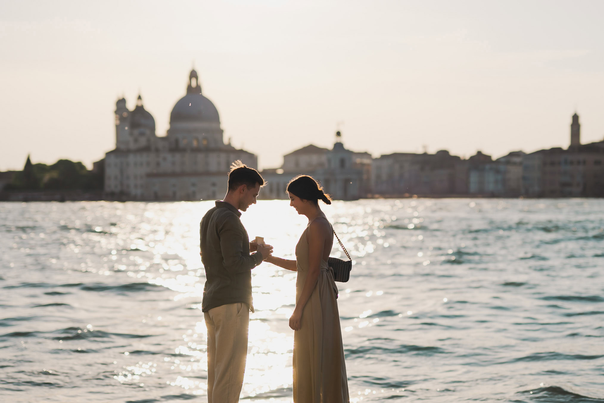 Man proposing to his girlfriend at sunset on San Giorgio Maggiore island