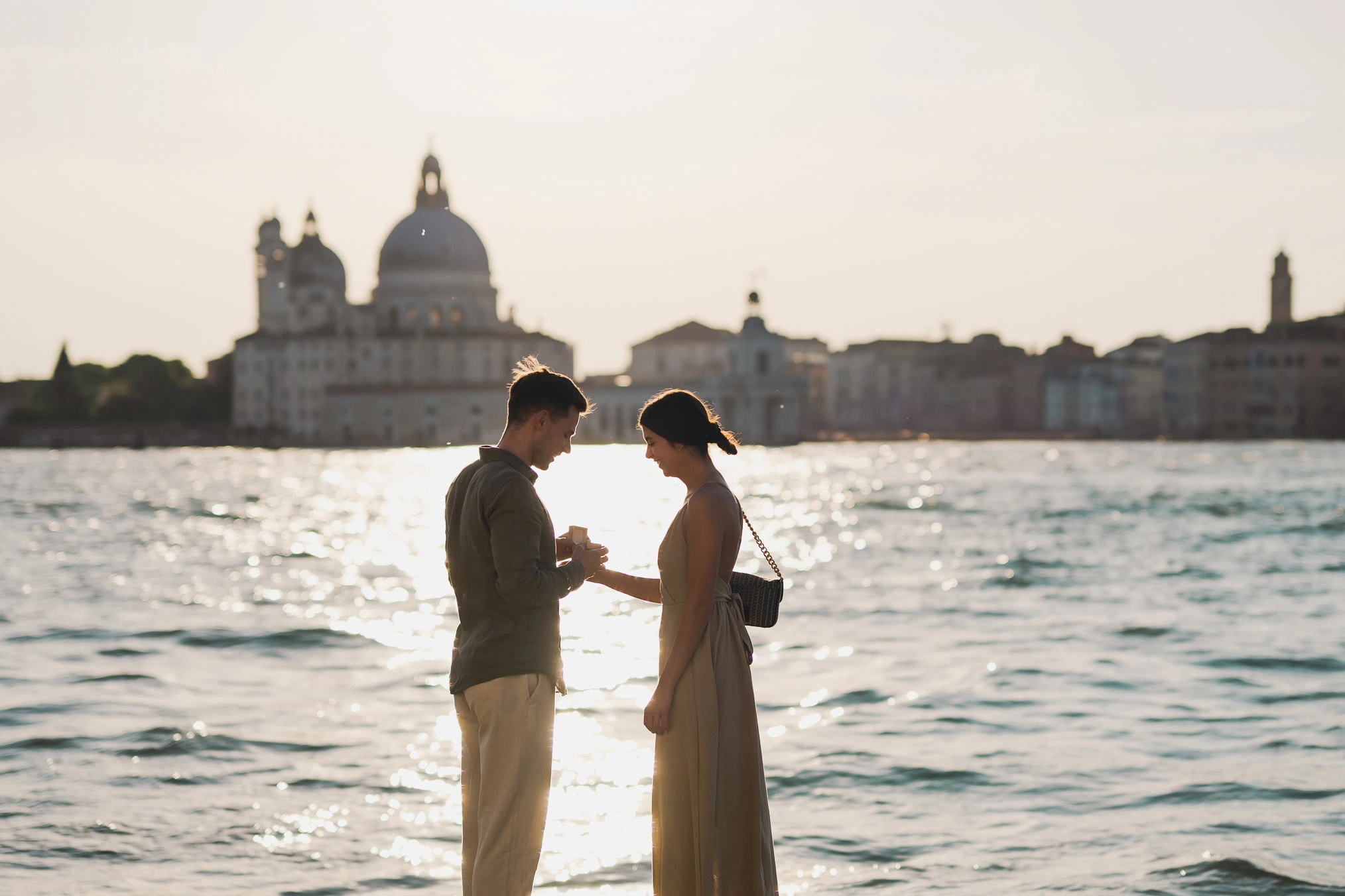 Man proposing to his girlfriend at sunset on San Giorgio Maggiore island