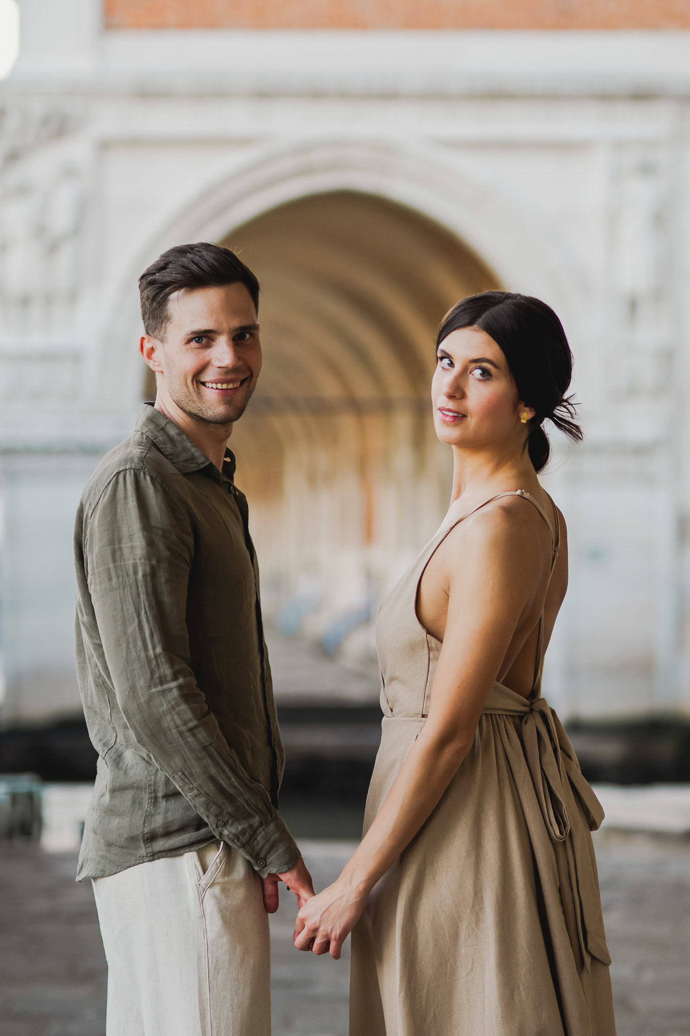 Engaged couple walking hand in hand through San Marco district