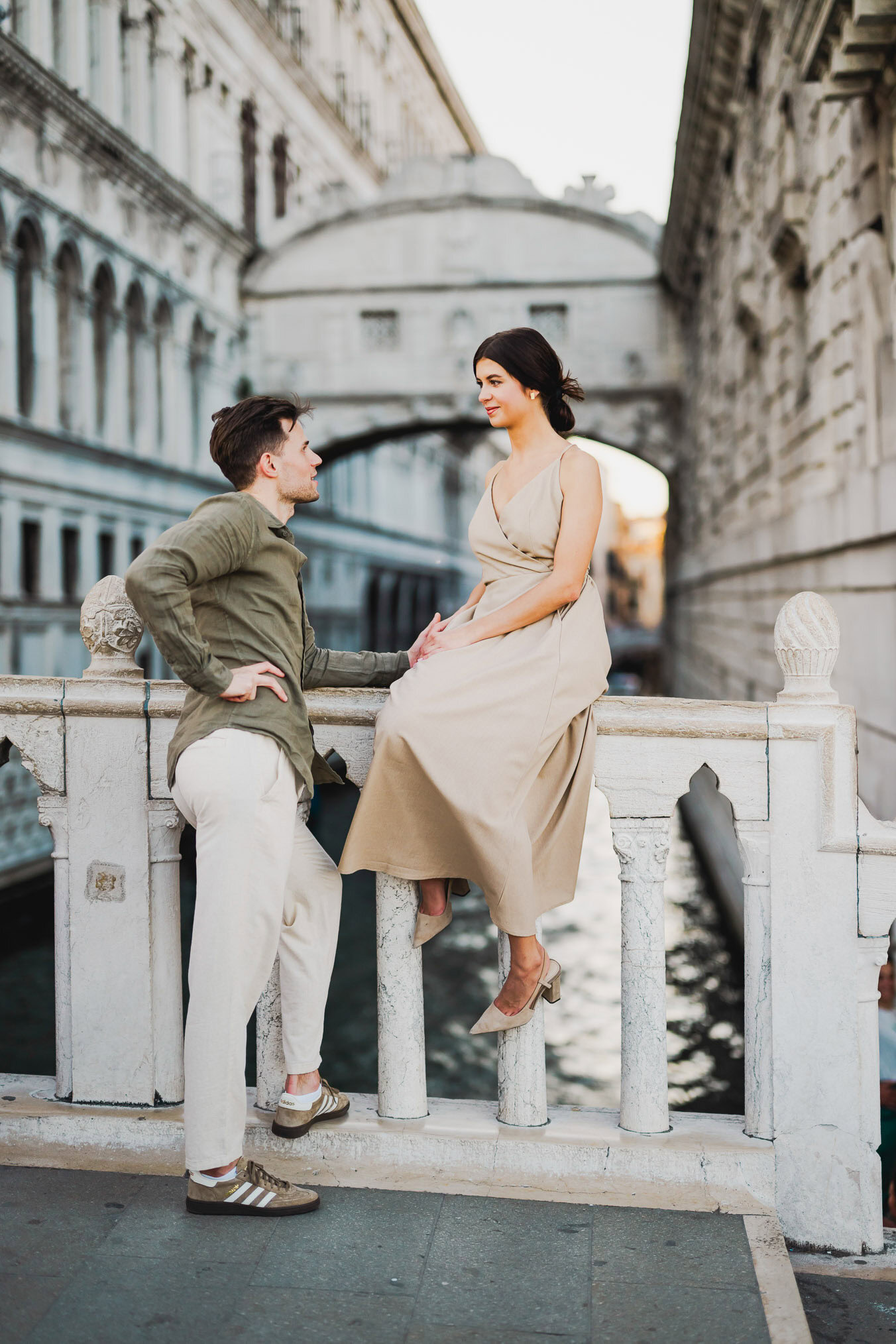 Engaged couple walking hand in hand through San Marco district