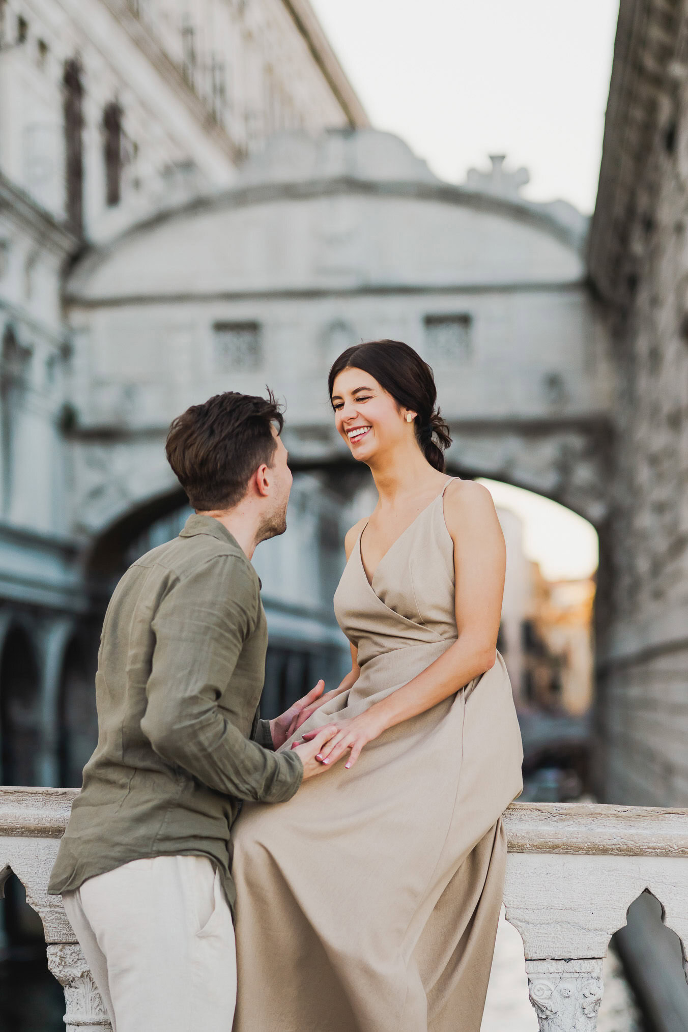 Engaged couple walking hand in hand through San Marco district