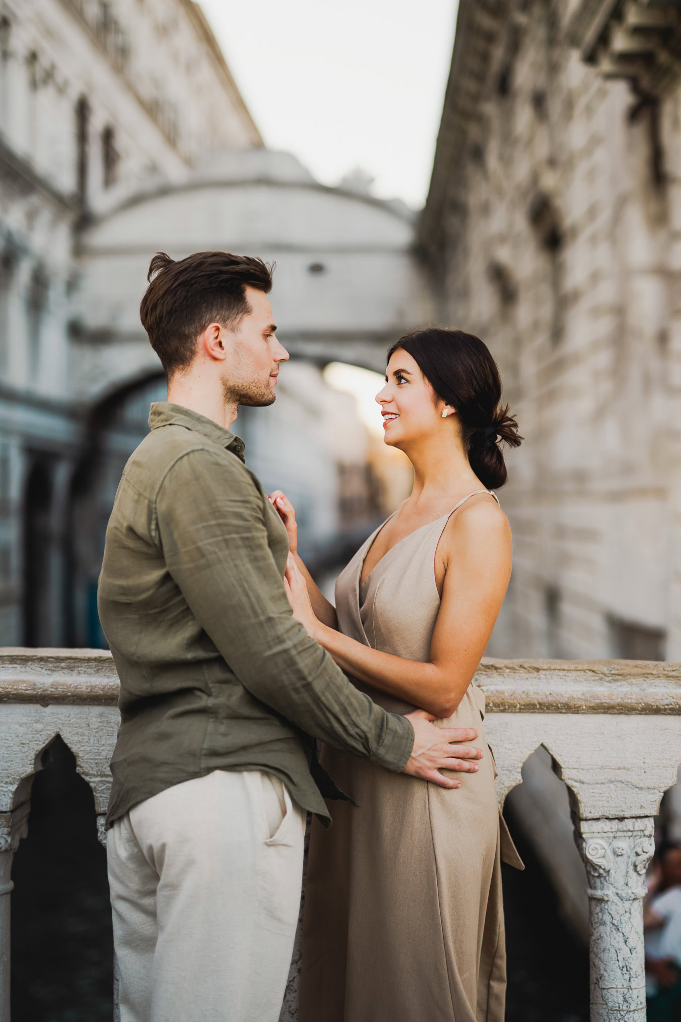 Engaged couple walking hand in hand through San Marco district