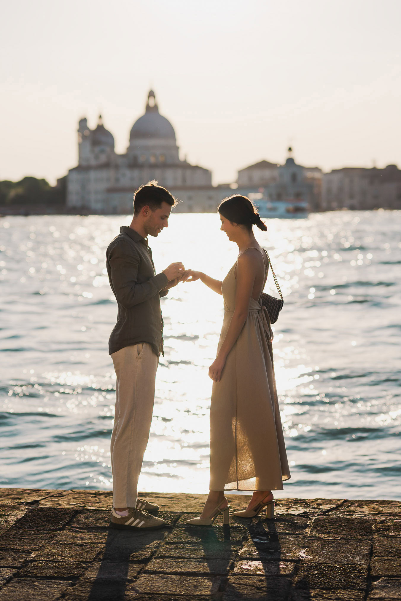 Man proposing to his girlfriend at sunset on San Giorgio Maggiore island