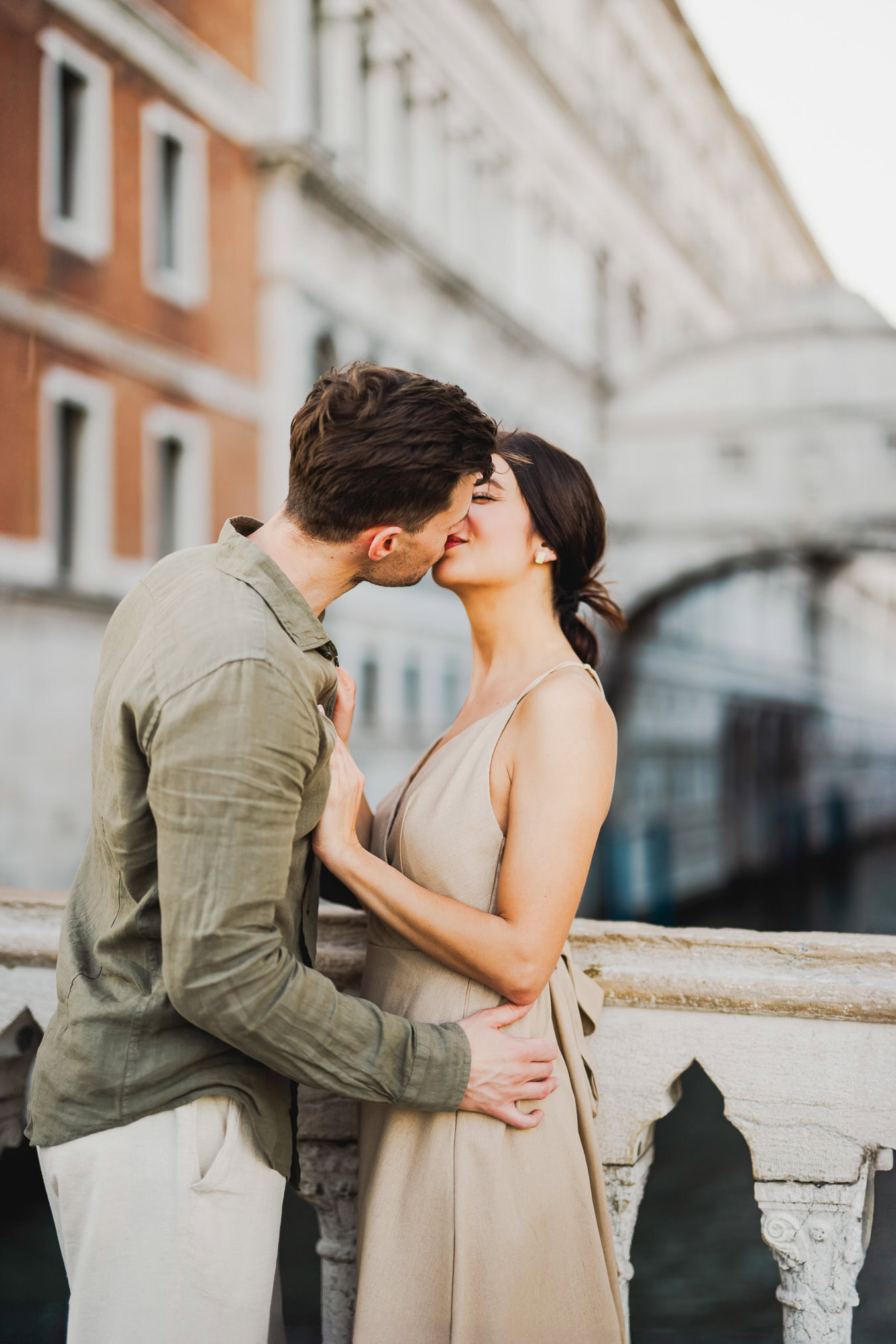 Engaged couple walking hand in hand through San Marco district