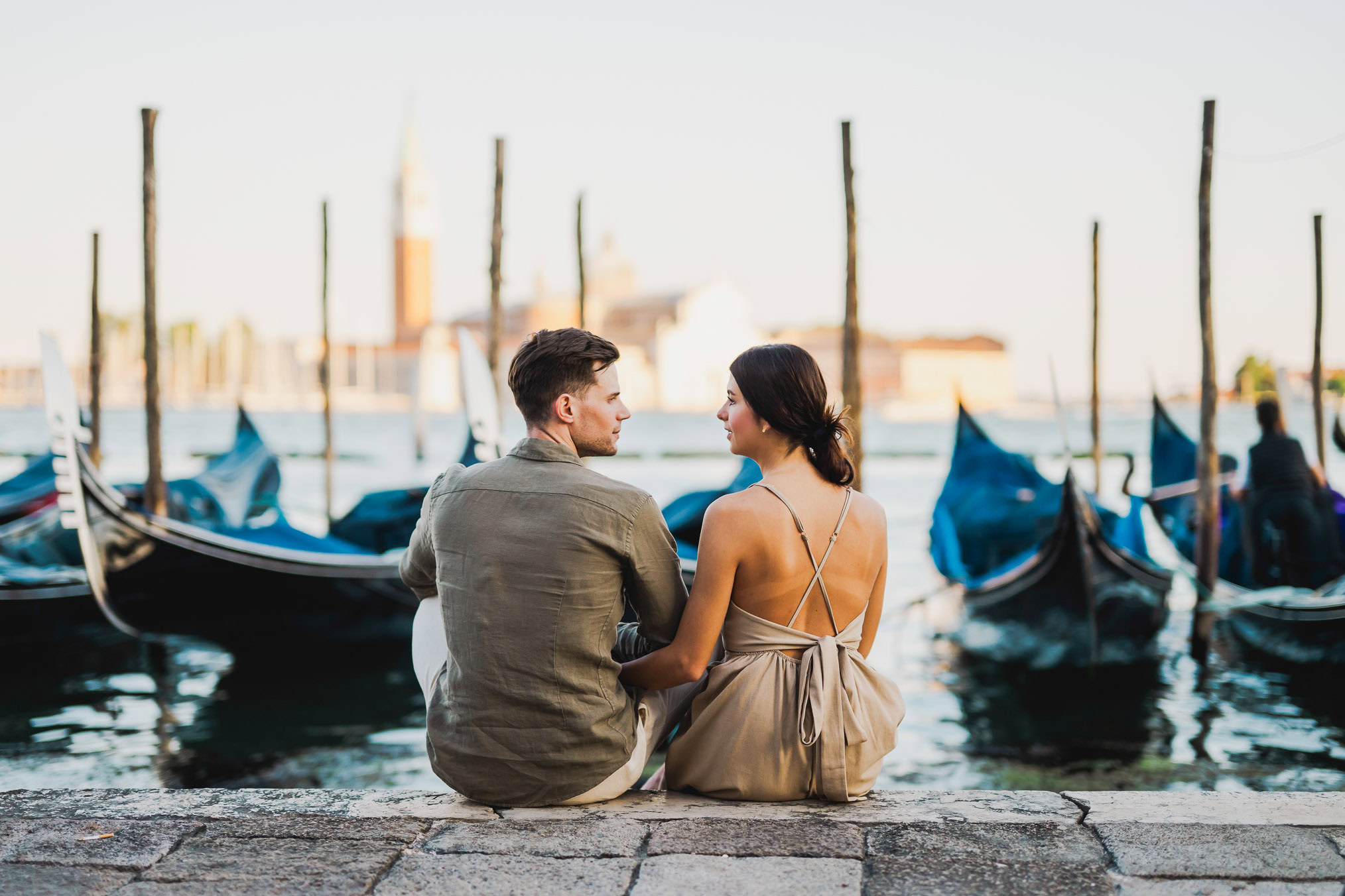 Engaged couple walking hand in hand through San Marco district