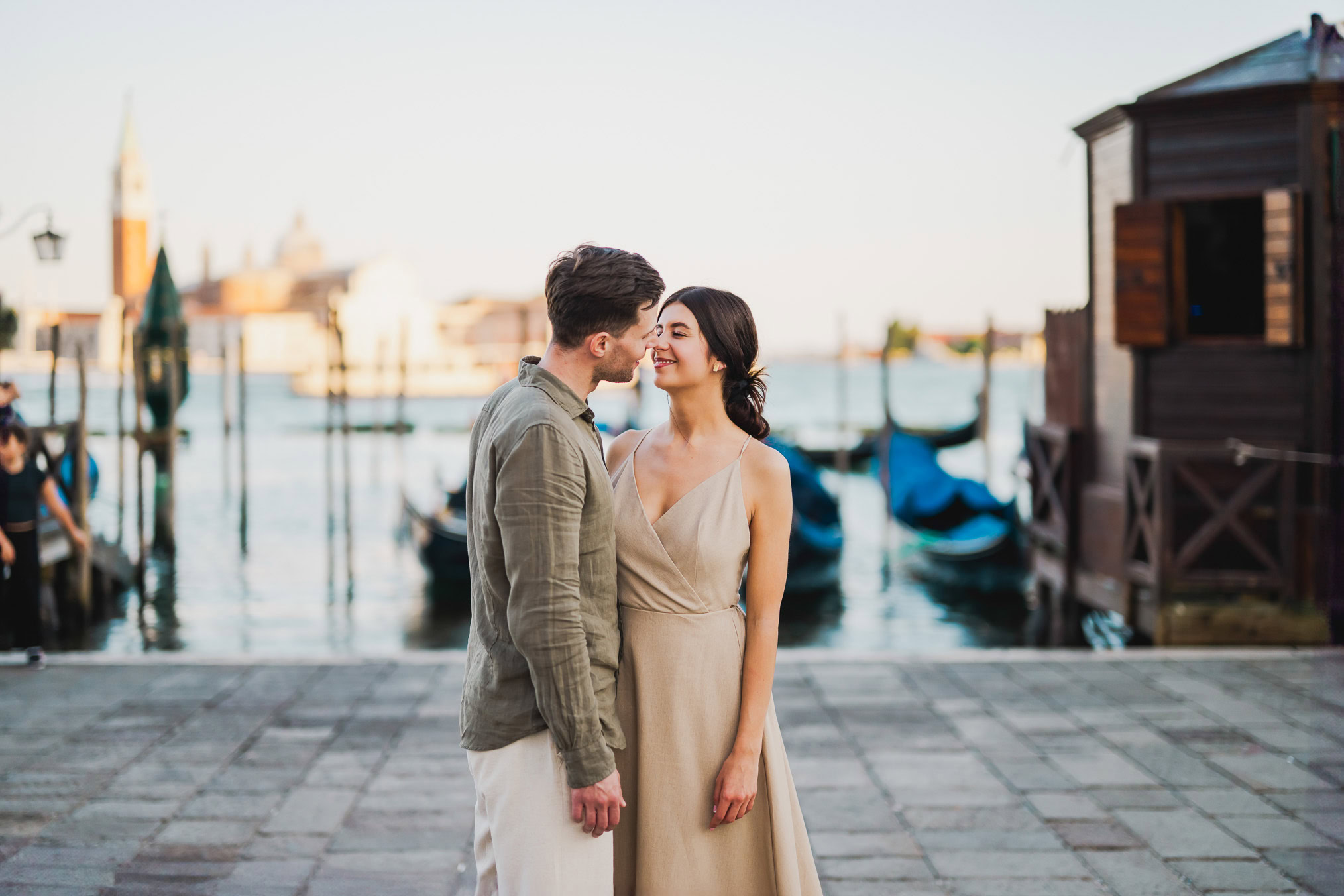 Engaged couple walking hand in hand through San Marco district