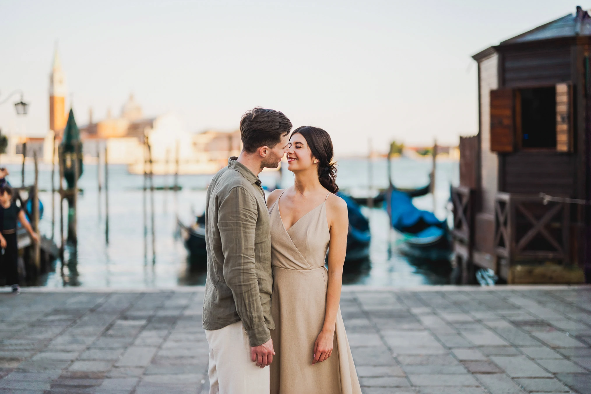 Engaged couple walking hand in hand through San Marco district