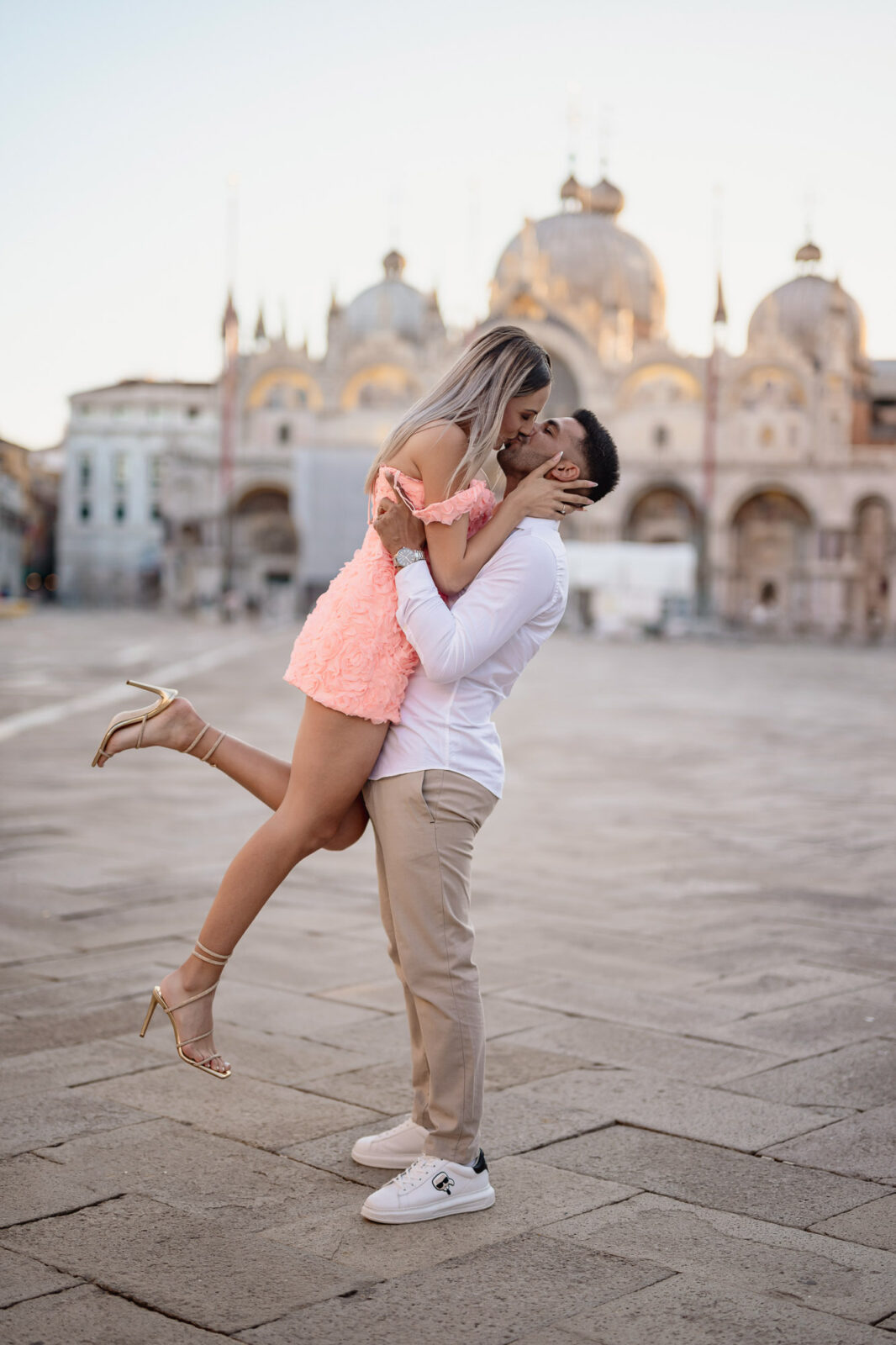 Romantic couple in Venice, with St. Mark's Basilica in the background, perfect for proposal photos.