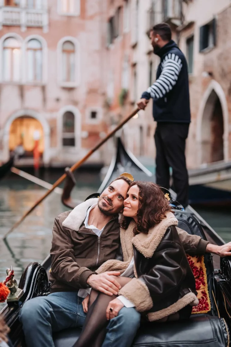 Gondola ride through Venice canals with a romantic couple, capturing proposal and engagement moments.