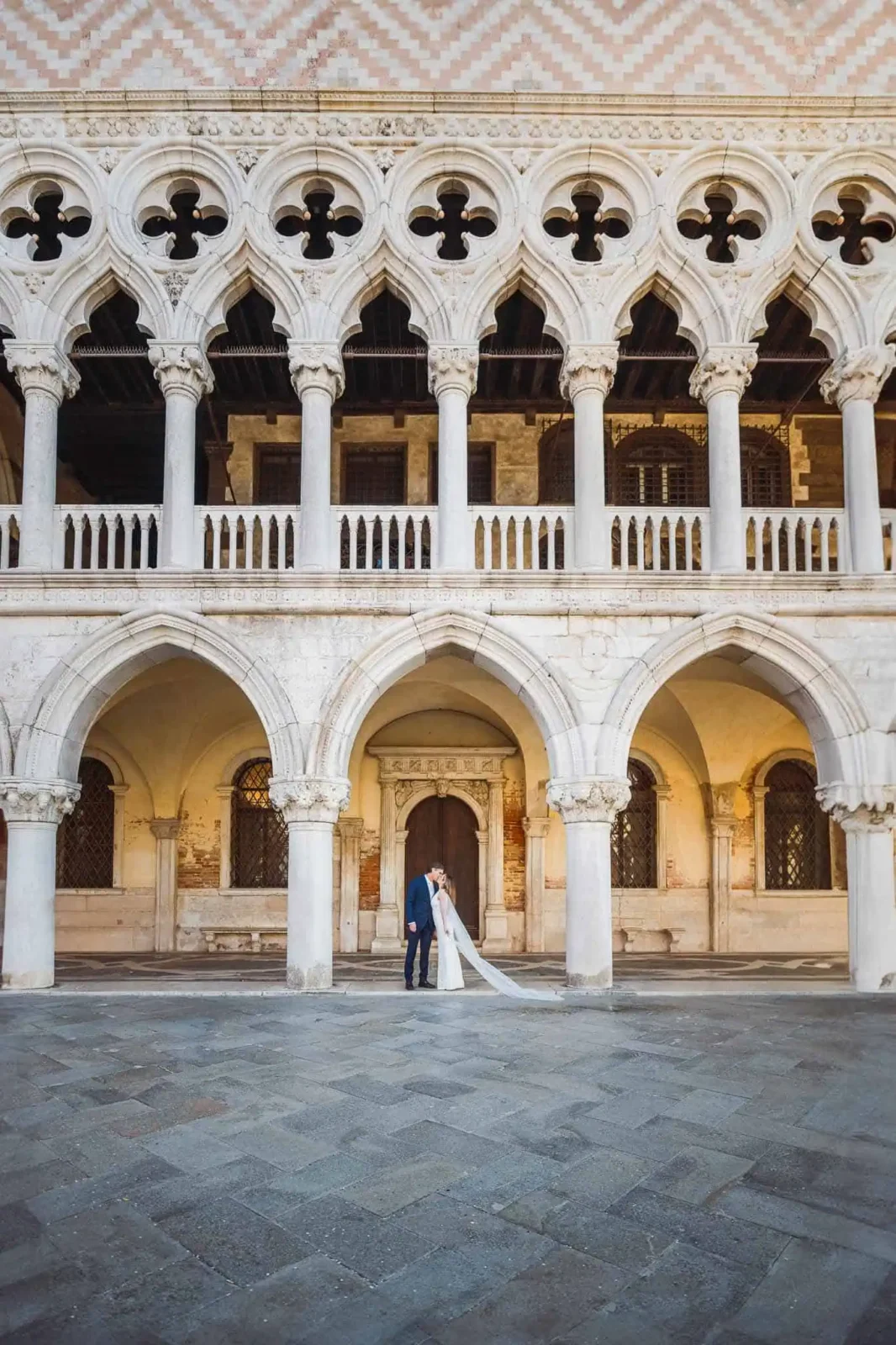 Elegant Venice couple wedding photo in historic Gothic architecture.