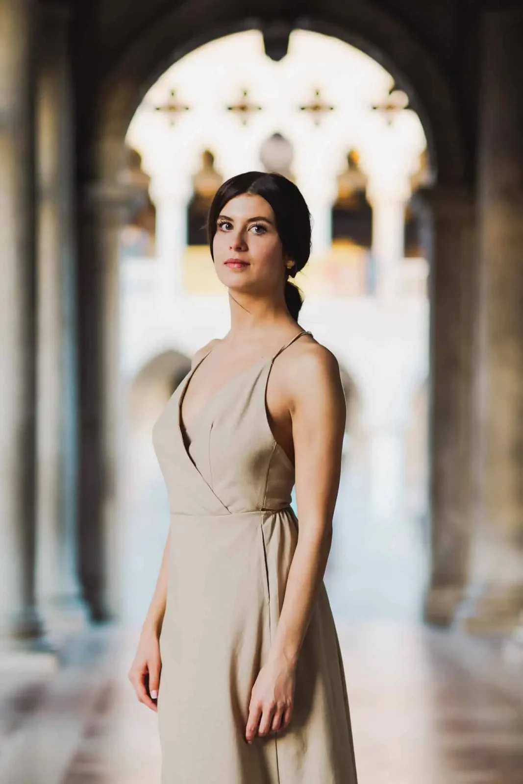 Elegant woman in beige dress at Venice landmark, romantic wedding photoshoot, Venice wedding photographer scene, Italy.