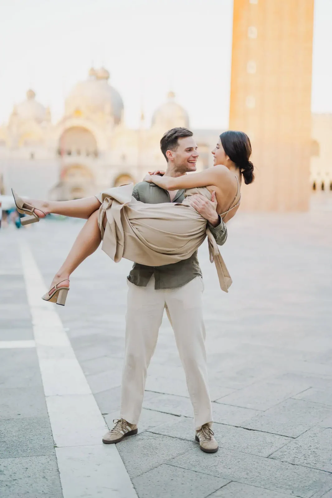 1. Smiling couple in Venice, Italy, with historic architecture in background.