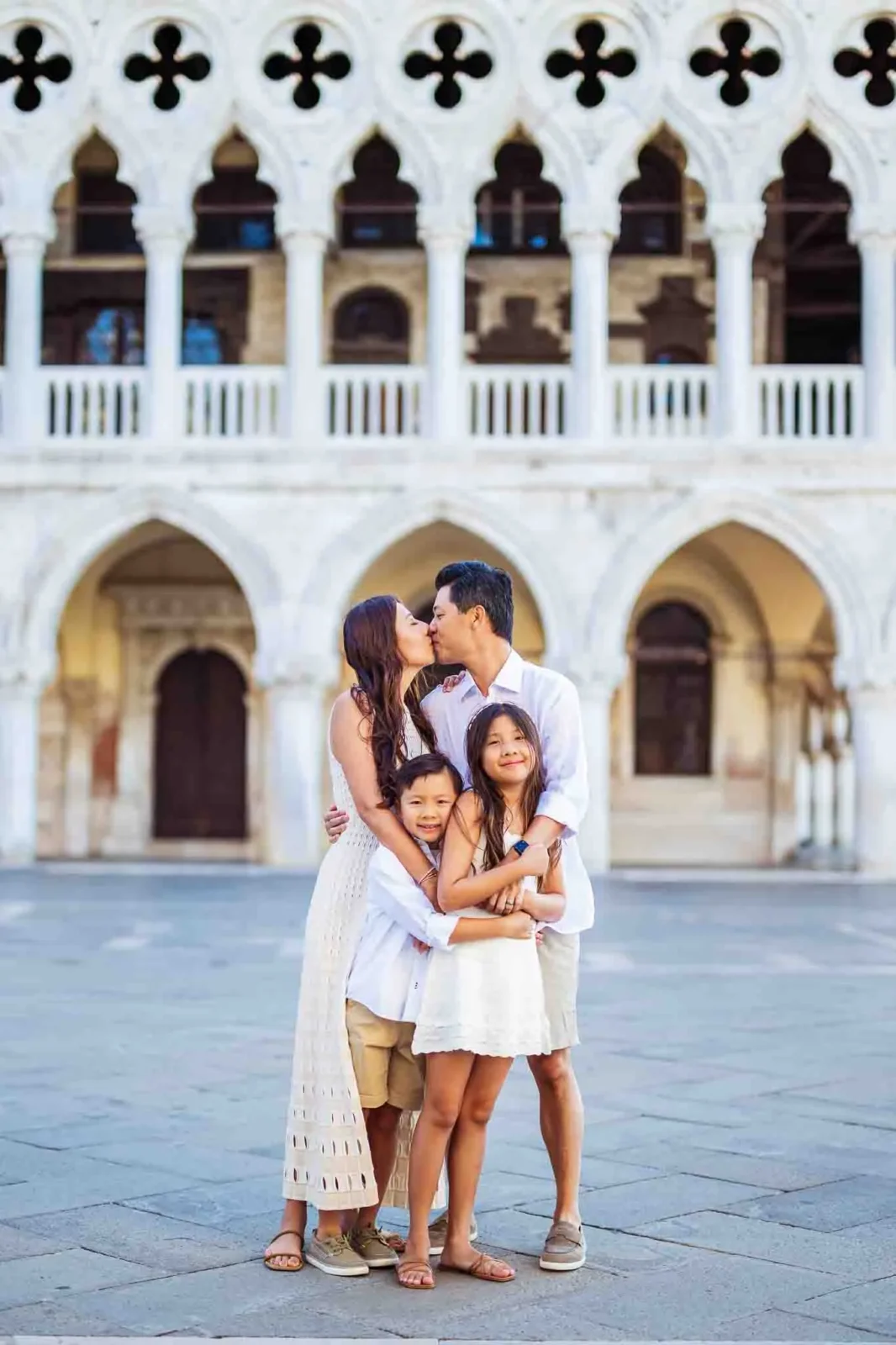 Romantic family portrait in Venice at sunset, capturing love and happiness in iconic surroundings.