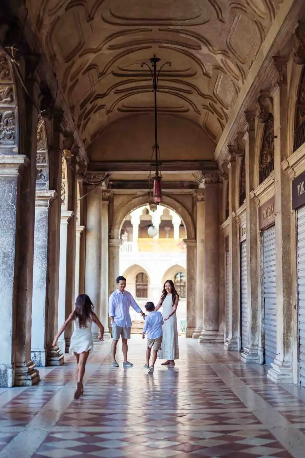 Elegant family portrait in Venetian architecture authentic setting.