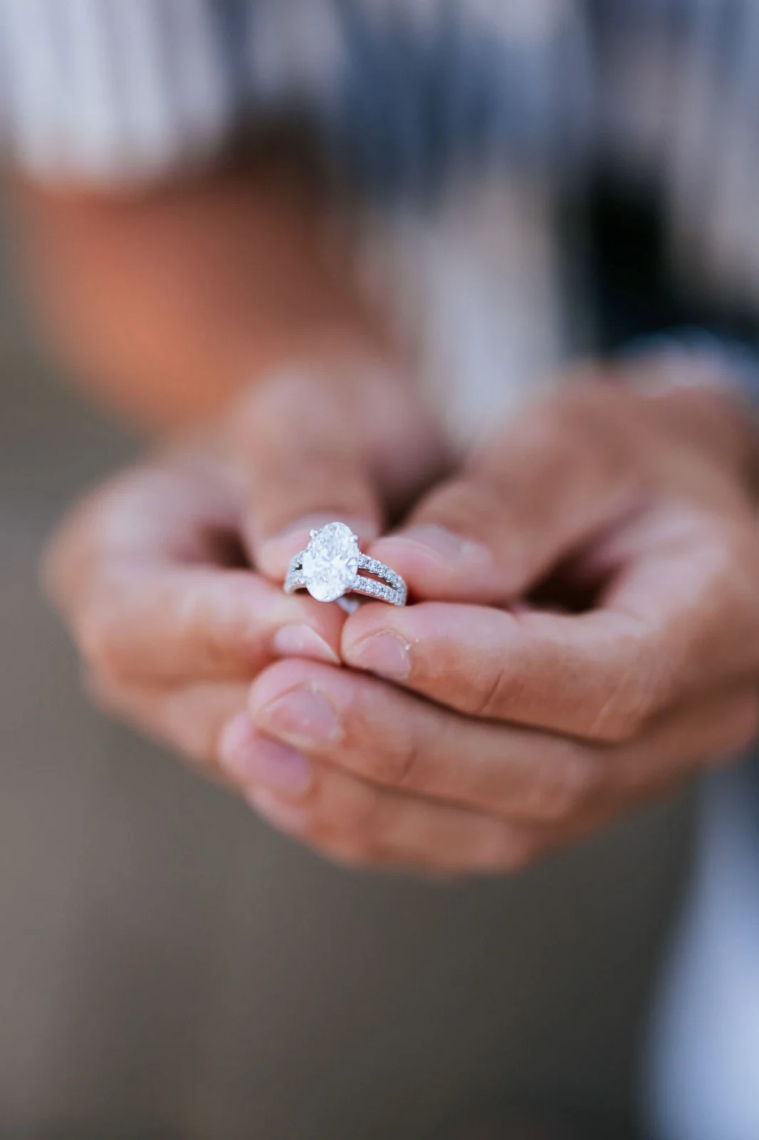 Elegant diamond engagement ring held by a person's hand in Venice.