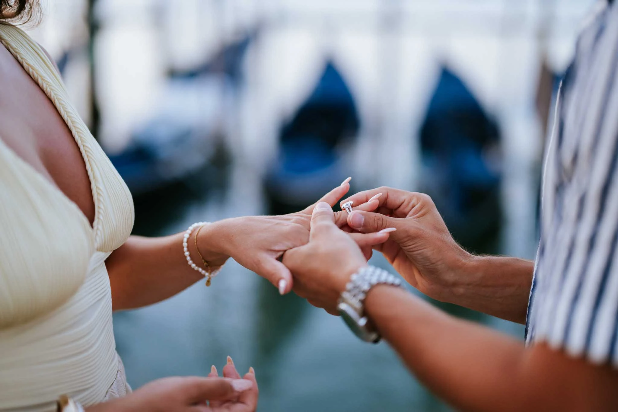 Elegant bride with diamond ring exchange during Venice proposal, capturing romantic wedding moments.